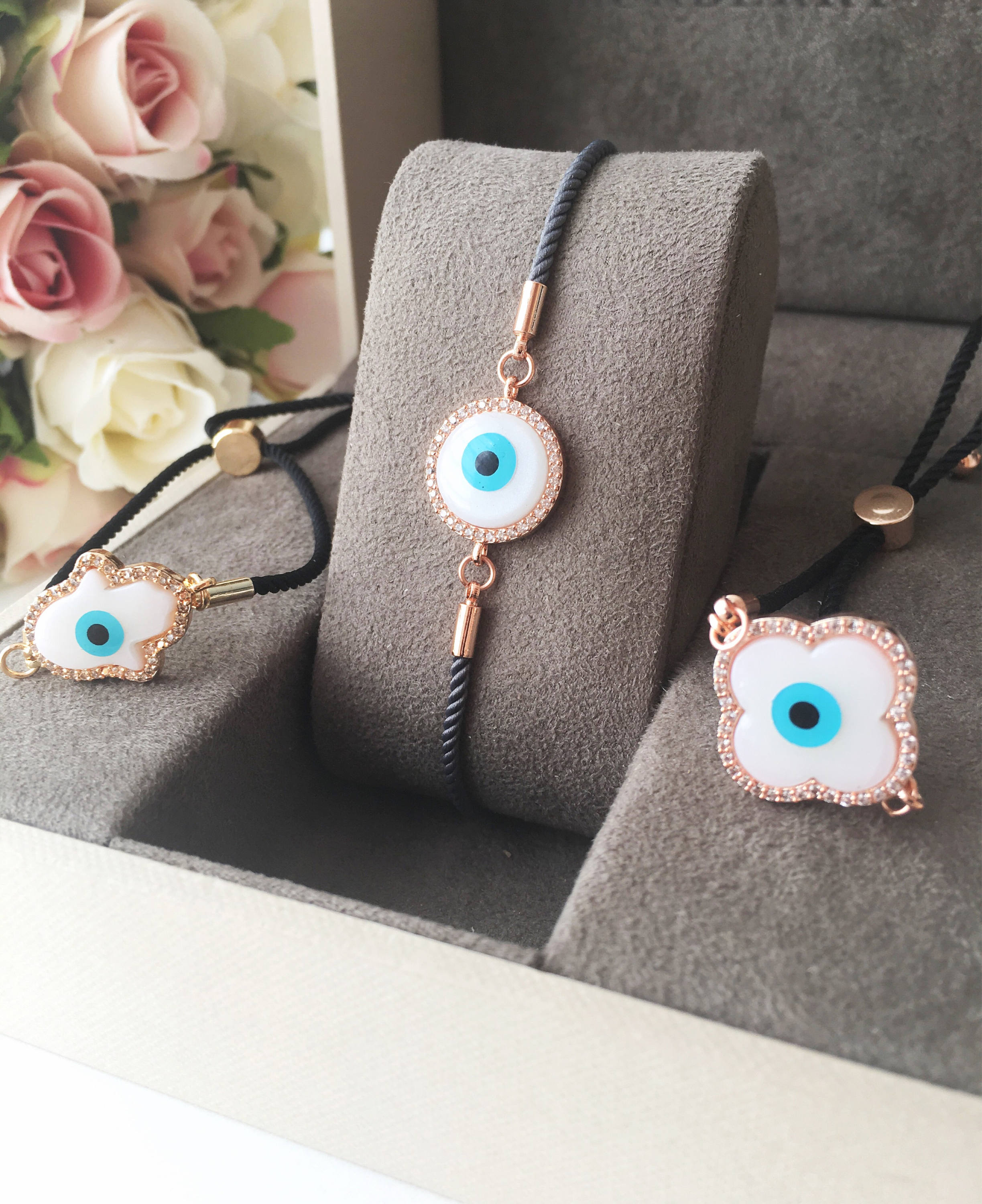 Handmade Greek Evil Eye Bracelet set in rose gold featuring Hamsa and Clover charms with zirconia accents.