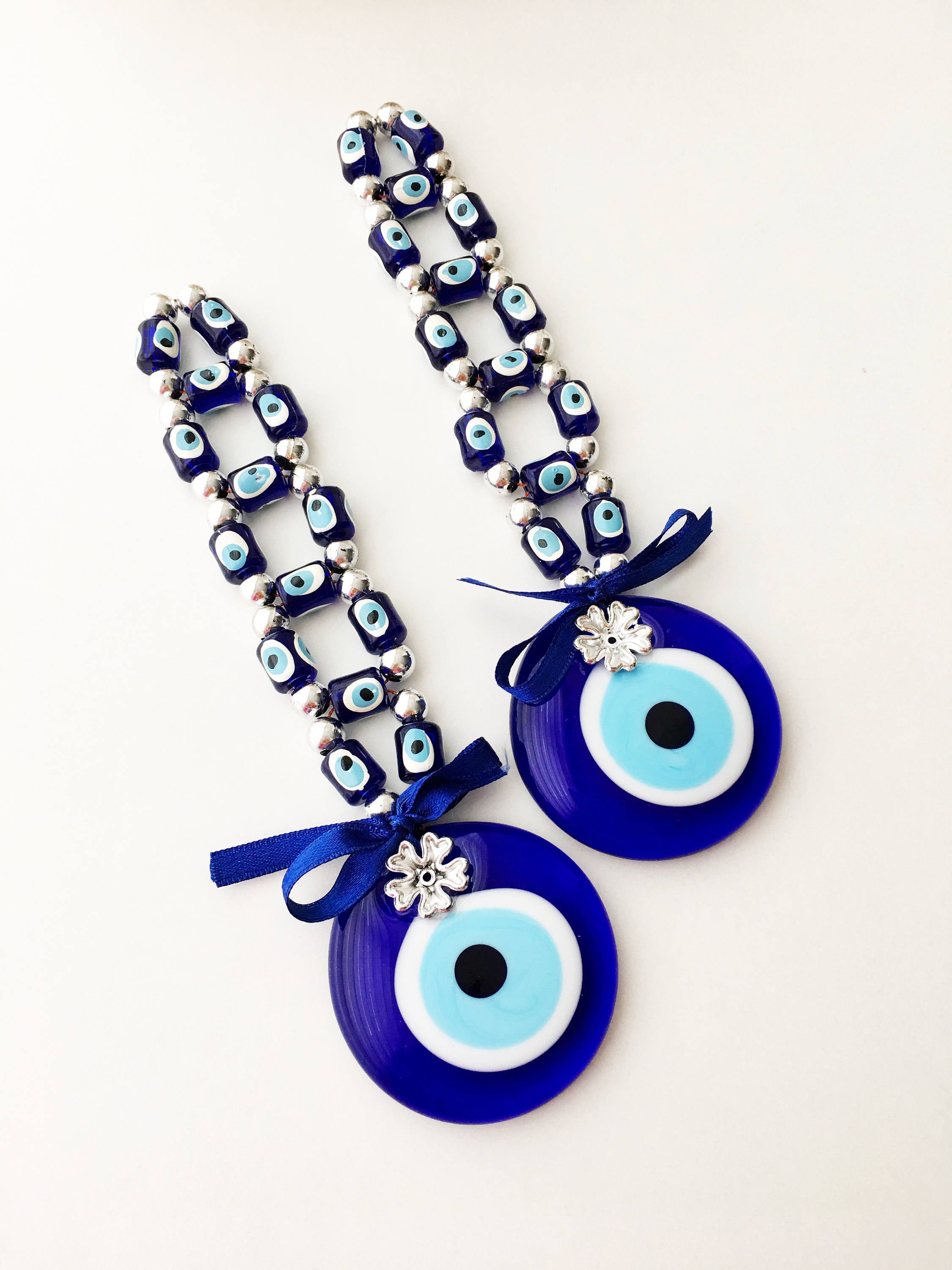 A beautifully crafted Greek Evil Eye Wall Hanging featuring large and small blue evil eye beads, symbolizing protection and good luck.