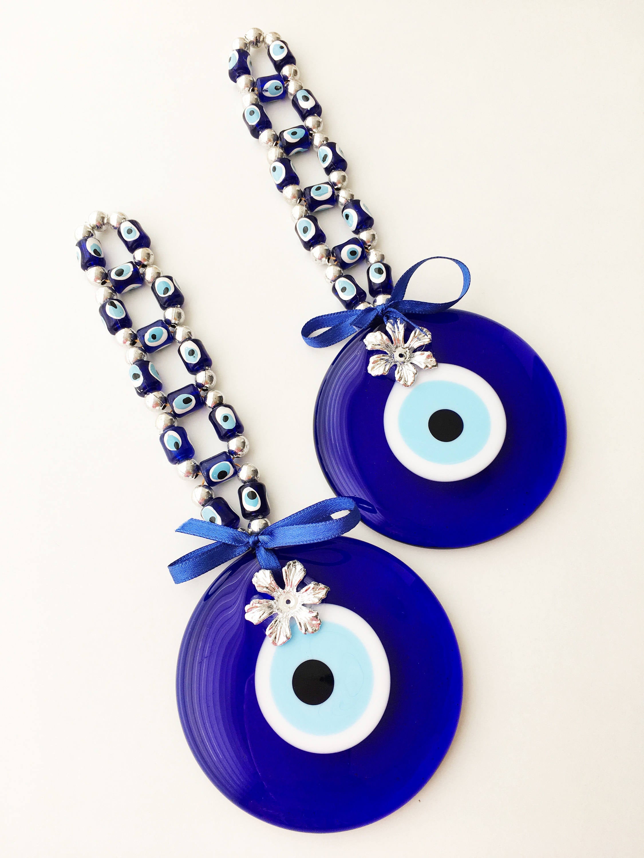 A beautifully crafted Greek Evil Eye Wall Hanging featuring large and small blue evil eye beads, symbolizing protection and good luck.