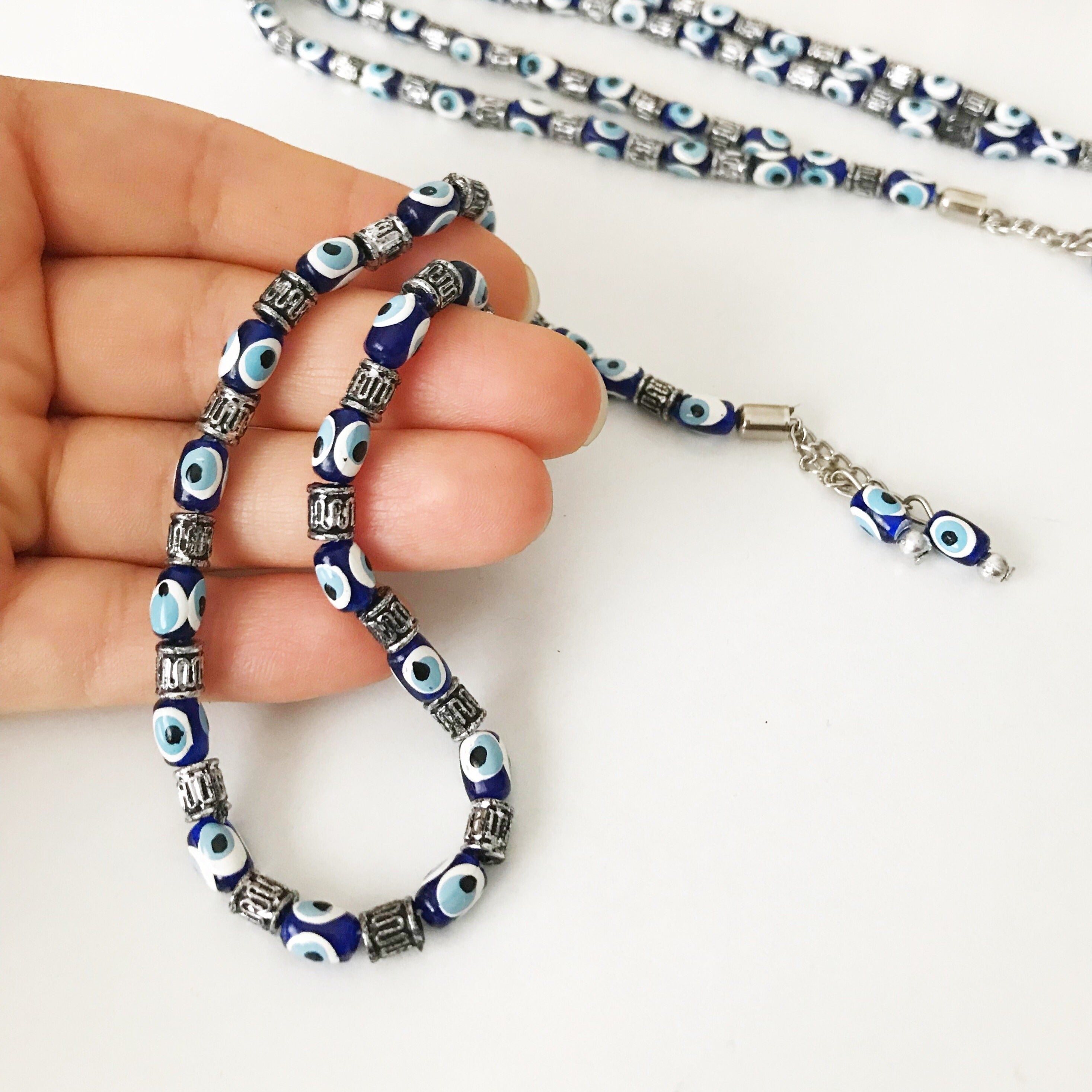 Handmade Greek komboloi featuring resin evil eye beads with silver accents, measuring 24cm in length.