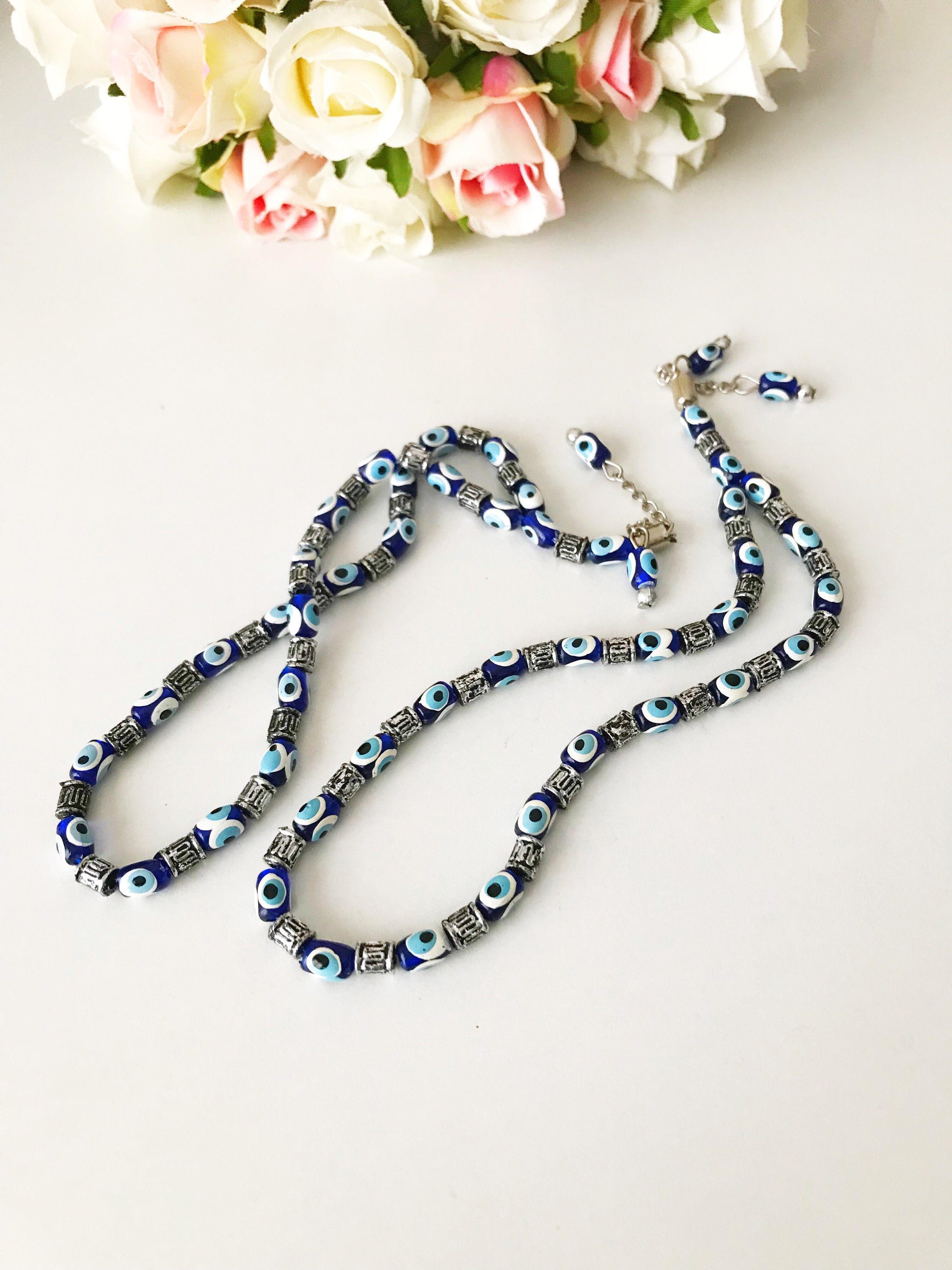 Handmade Greek komboloi featuring resin evil eye beads with silver accents, measuring 24cm in length.