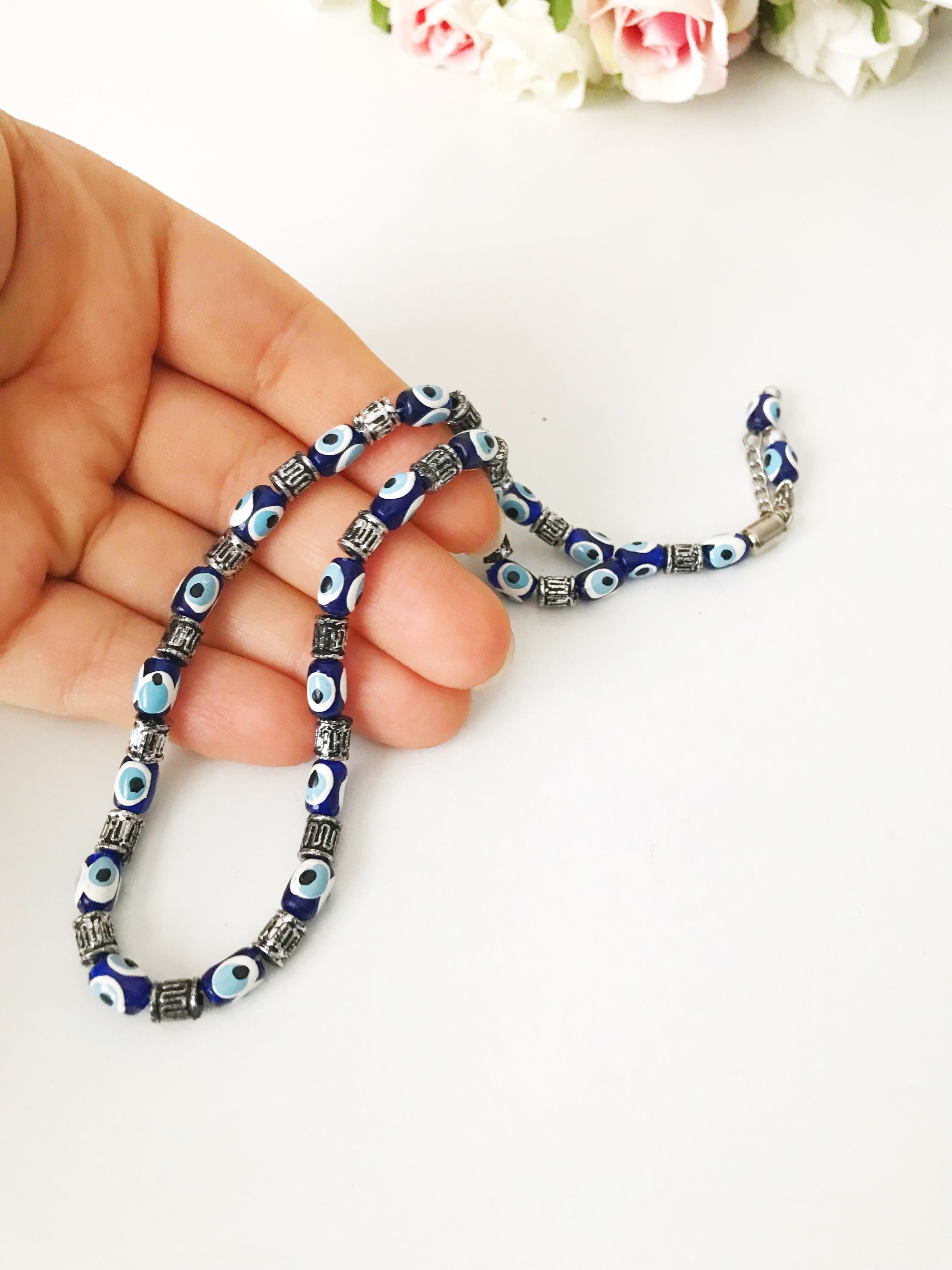 Handmade Greek komboloi featuring resin evil eye beads with silver accents, measuring 24cm in length.