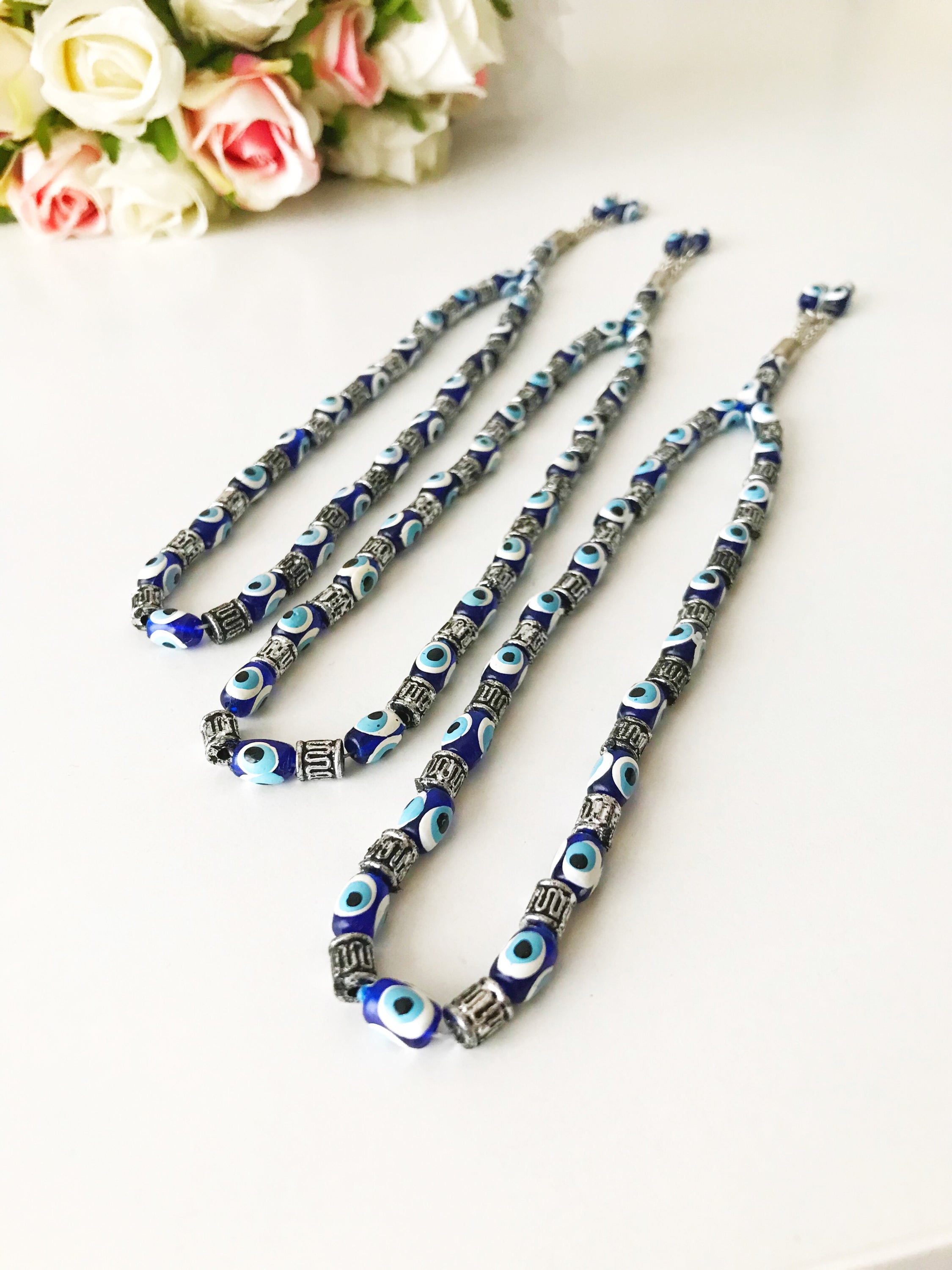 Handmade Greek komboloi featuring resin evil eye beads with silver accents, measuring 24cm in length.