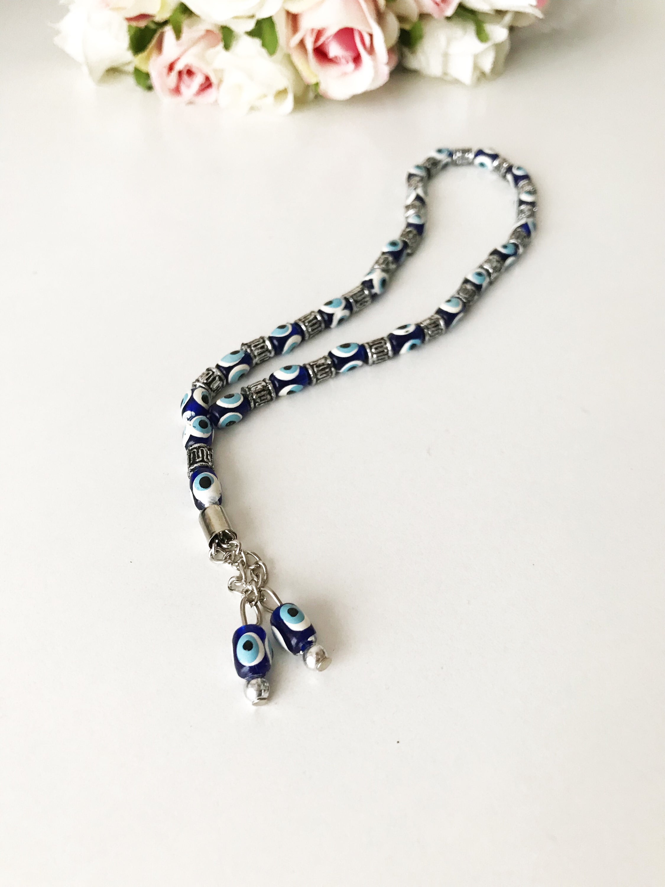 Handmade Greek komboloi featuring resin evil eye beads with silver accents, measuring 24cm in length.