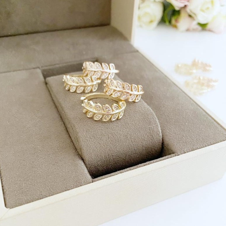 A beautiful gold adjustable Greek Leaf Ring featuring intricate zircon leaves, symbolizing elegance and nature-inspired design.