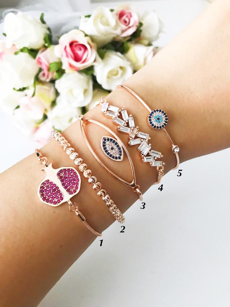 A beautiful Greek Lucky Evil Eye Bracelet in rose gold, showcasing intricate handmade details and an adjustable design.