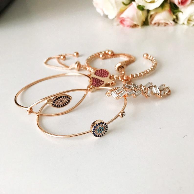 A beautiful Greek Lucky Evil Eye Bracelet in rose gold, showcasing intricate handmade details and an adjustable design.