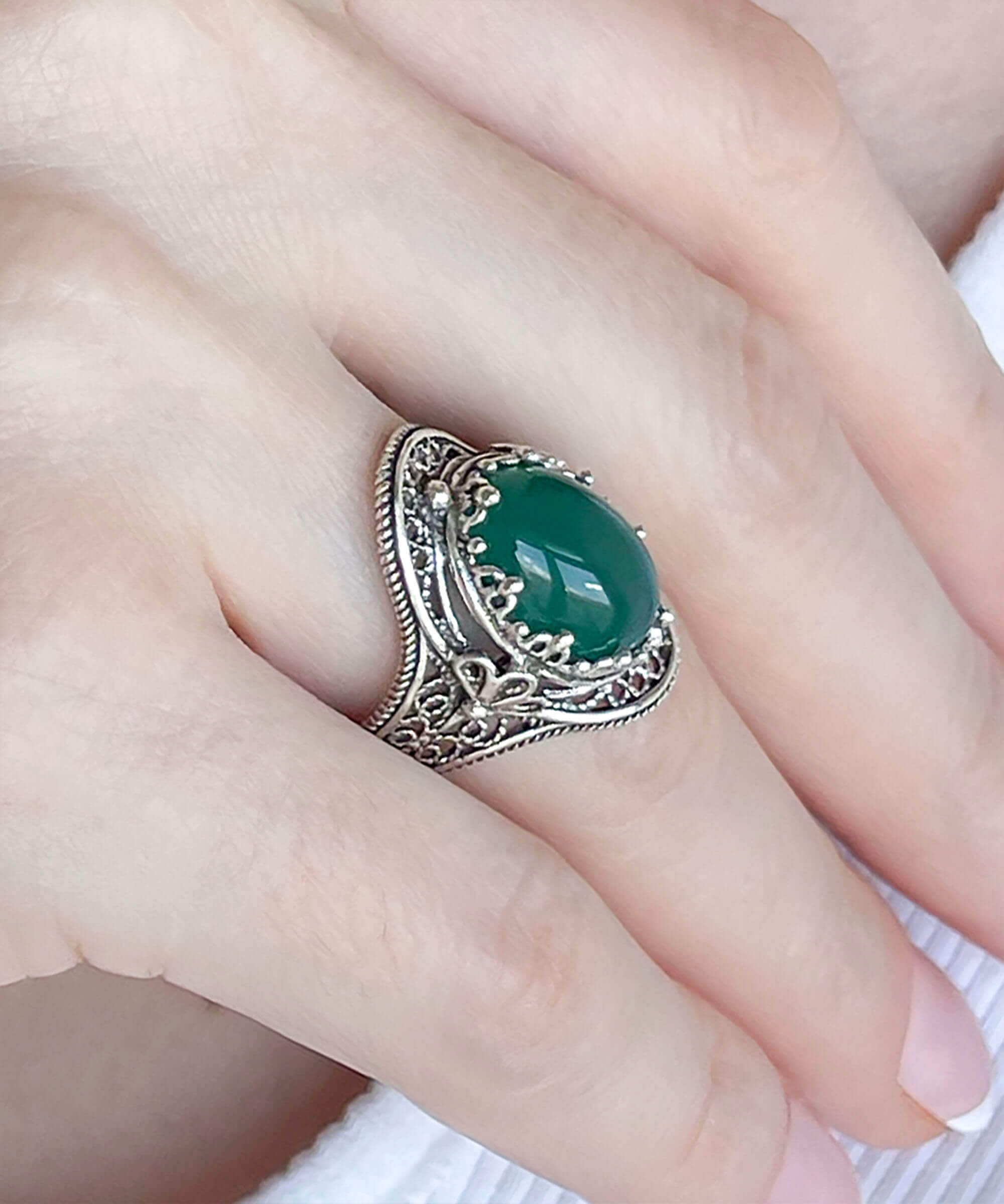 A beautiful handmade silver statement ring featuring a green agate gemstone in a filigree design, elegantly displayed in a gift box.