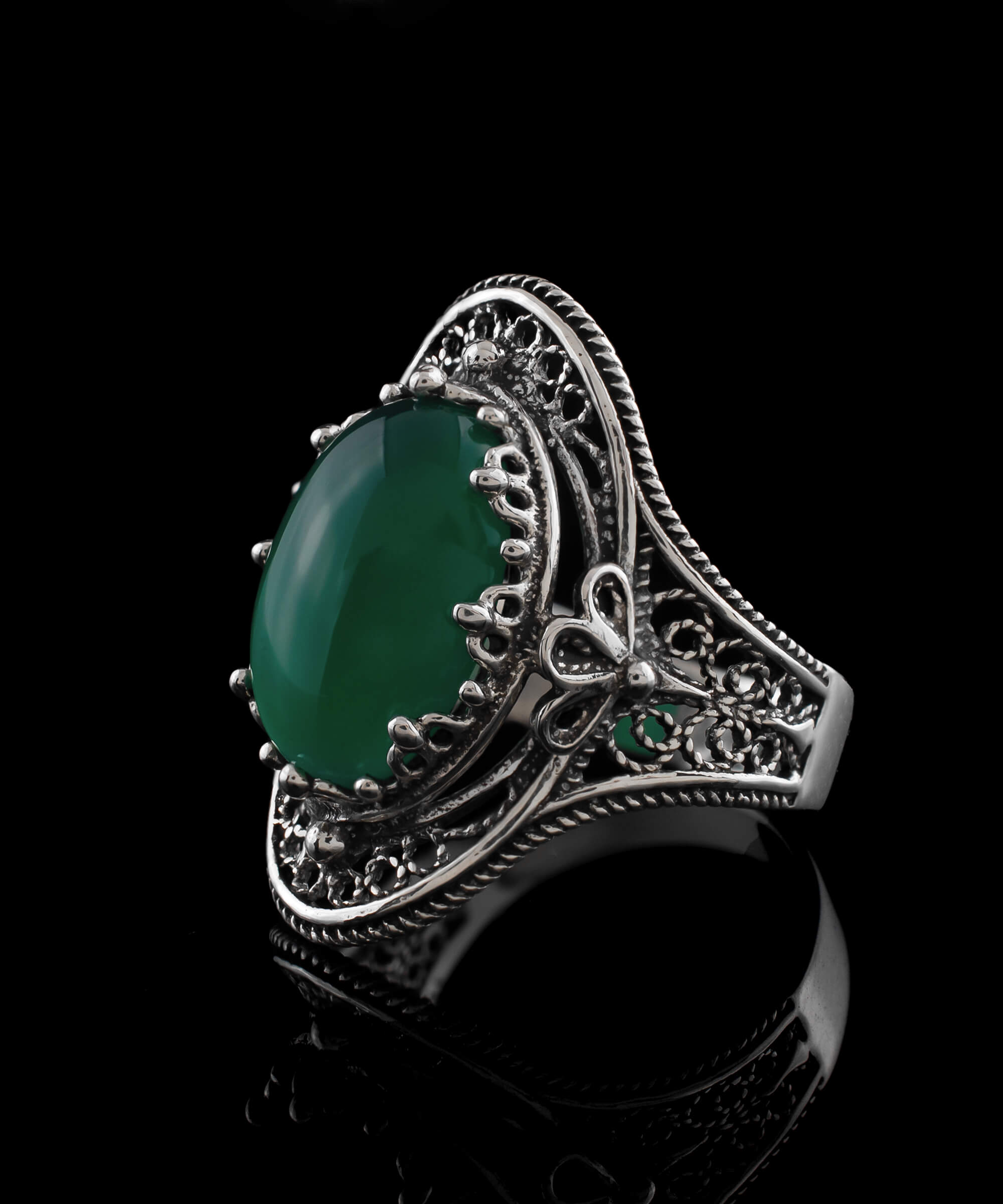 A beautiful handmade silver statement ring featuring a green agate gemstone in a filigree design, elegantly displayed in a gift box.