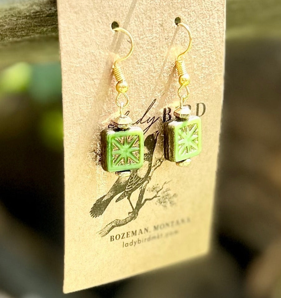 Elegant Green & Gold Star-Flower Etched Glass Earrings featuring Czech glass beads with intricate gold designs.