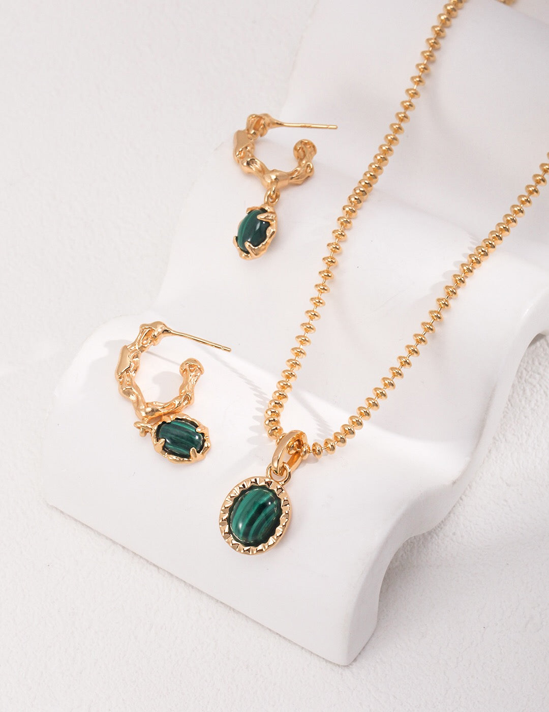 Elegant Green Malachite Hoop Earrings featuring gold vermeil accents, showcasing vibrant green hues and unique patterns.