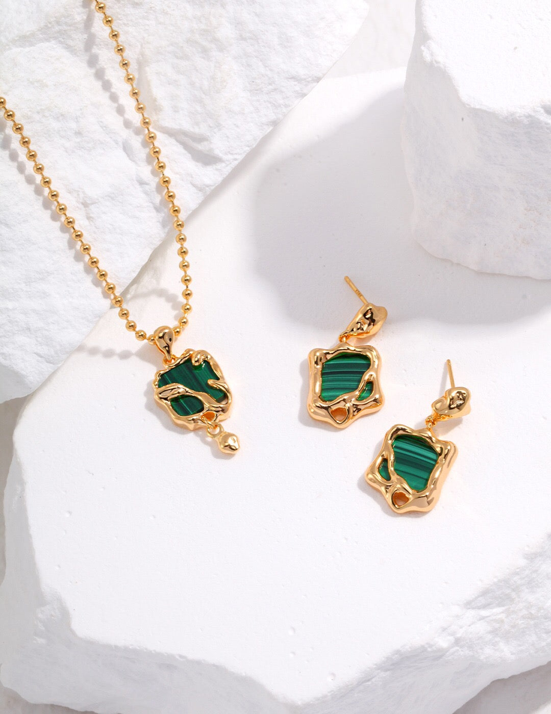 A handcrafted Green Malachite Pendant Necklace featuring a natural malachite stone set in gold vermeil, elegantly displayed on a soft background.