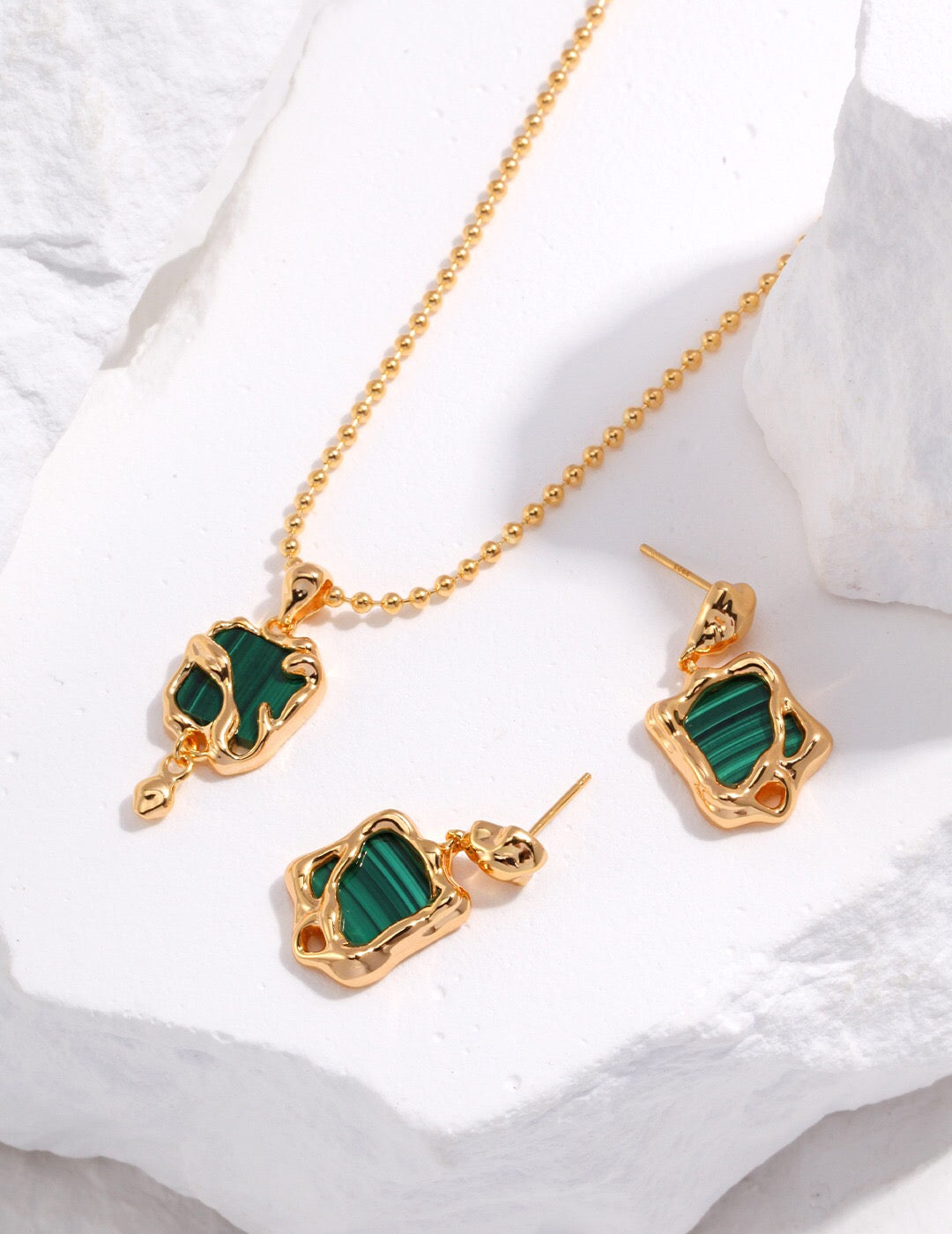 A handcrafted Green Malachite Pendant Necklace featuring a natural malachite stone set in gold vermeil, elegantly displayed on a soft background.