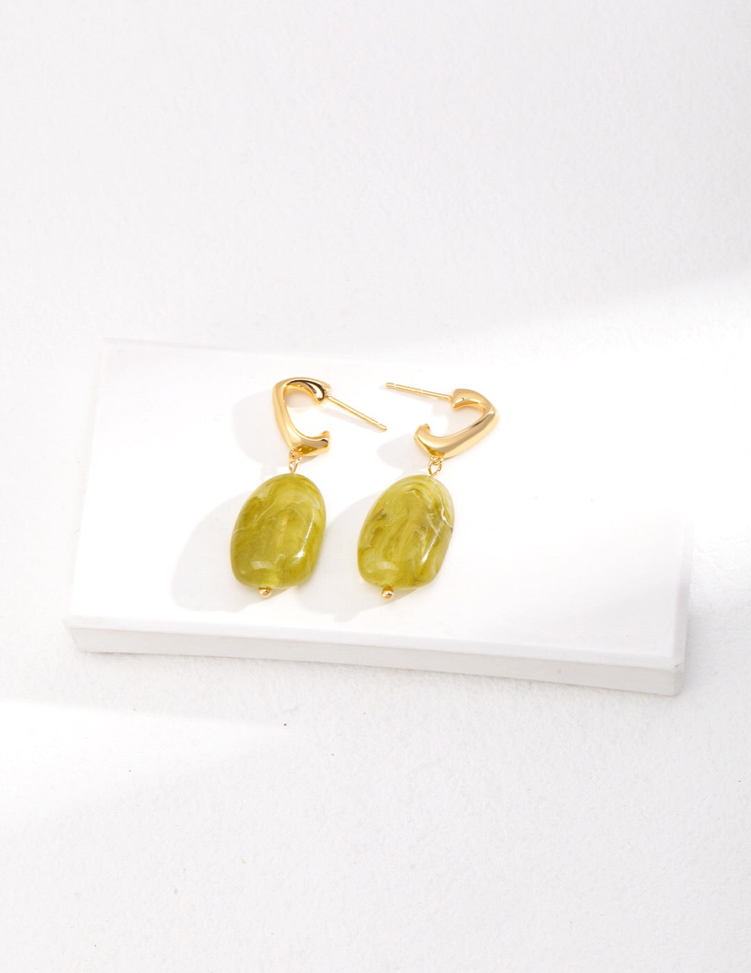 Elegant green resin stone drop earrings with gold vermeil finish, showcasing a unique handmade design.