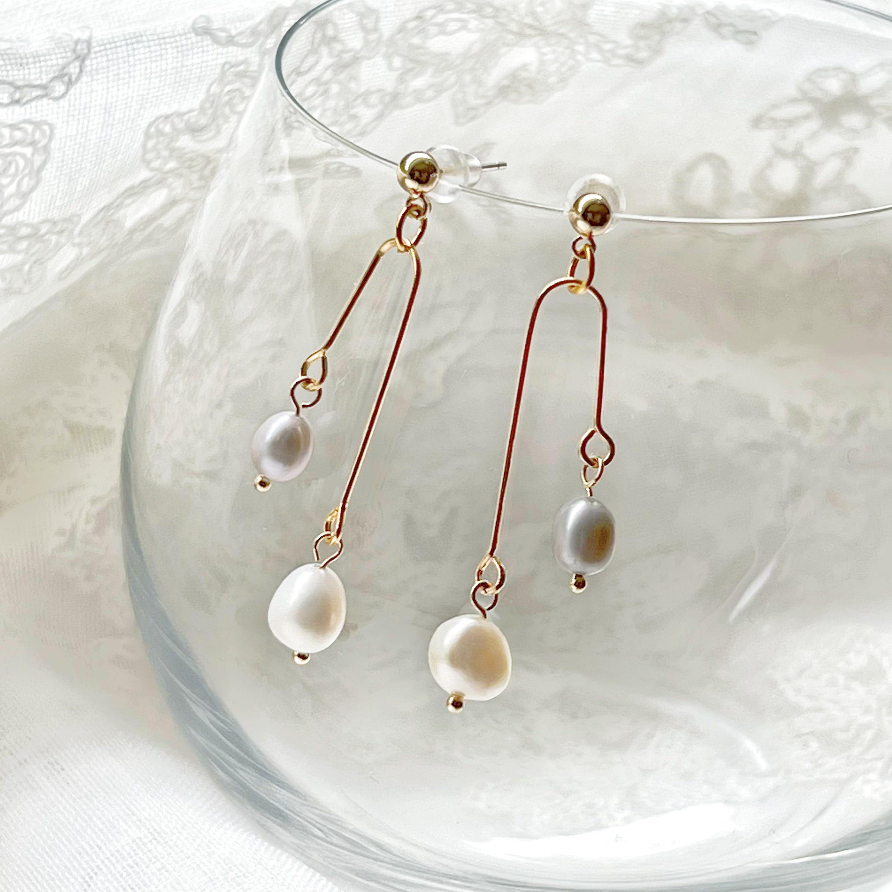 Elegant grey pearl drop earrings featuring freshwater baroque pearls and sterling silver studs.