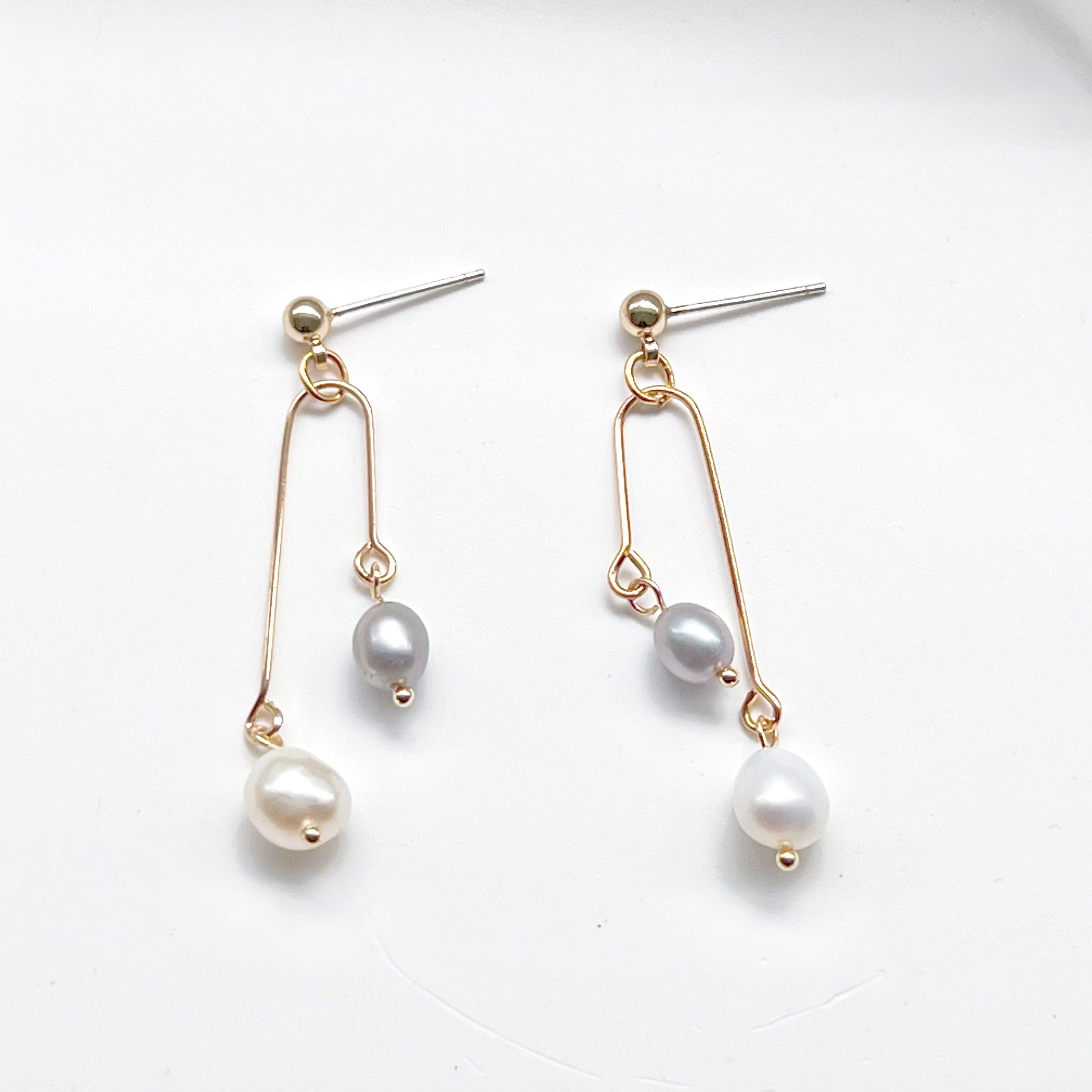 Elegant grey pearl drop earrings featuring freshwater baroque pearls and sterling silver studs.