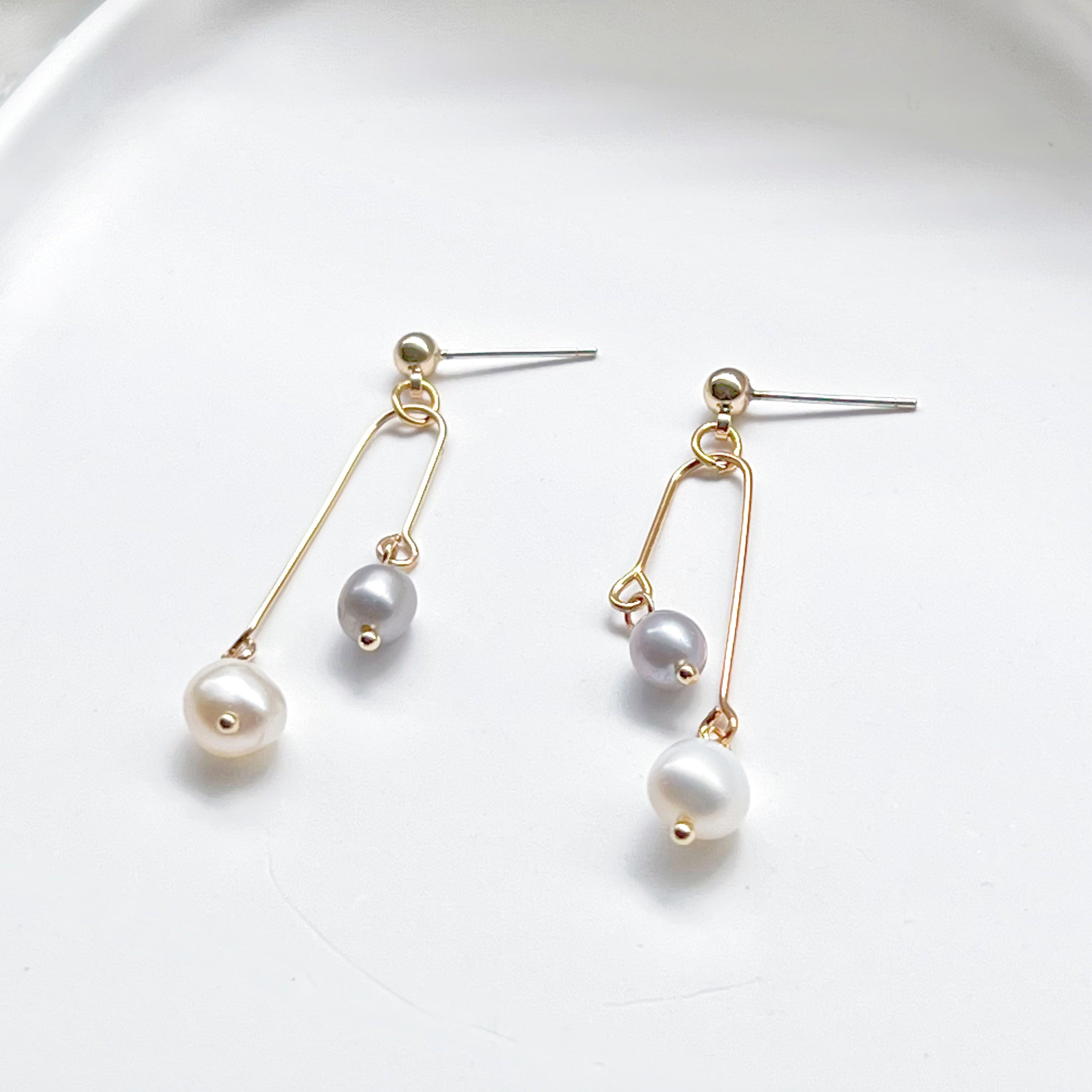 Elegant grey pearl drop earrings featuring freshwater baroque pearls and sterling silver studs.