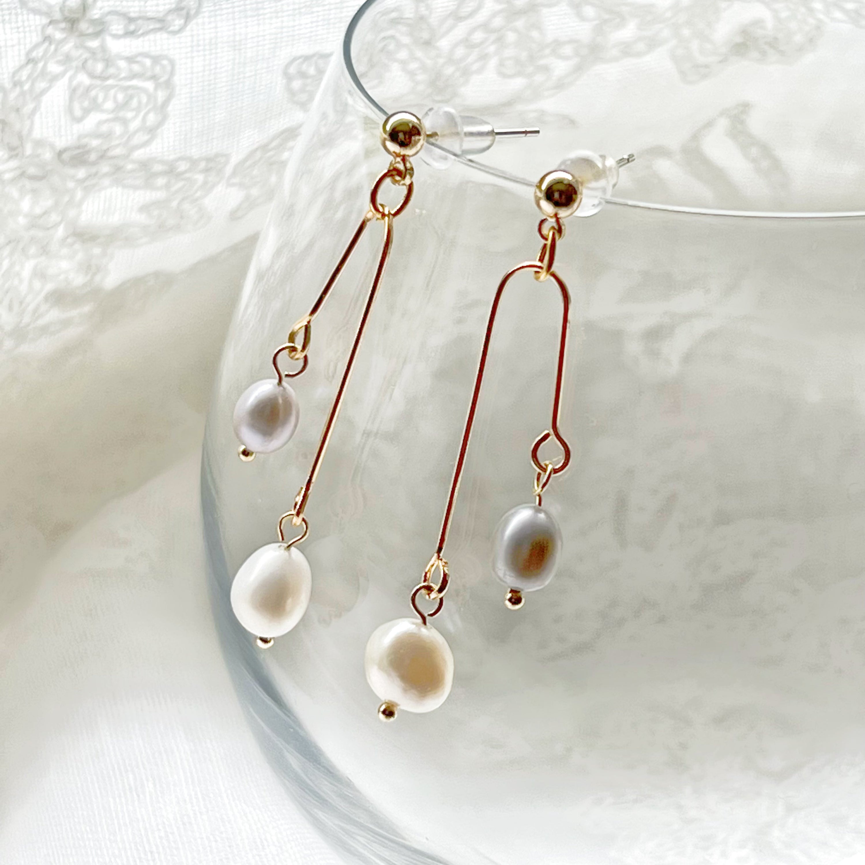 Elegant grey pearl drop earrings featuring freshwater baroque pearls and sterling silver studs.