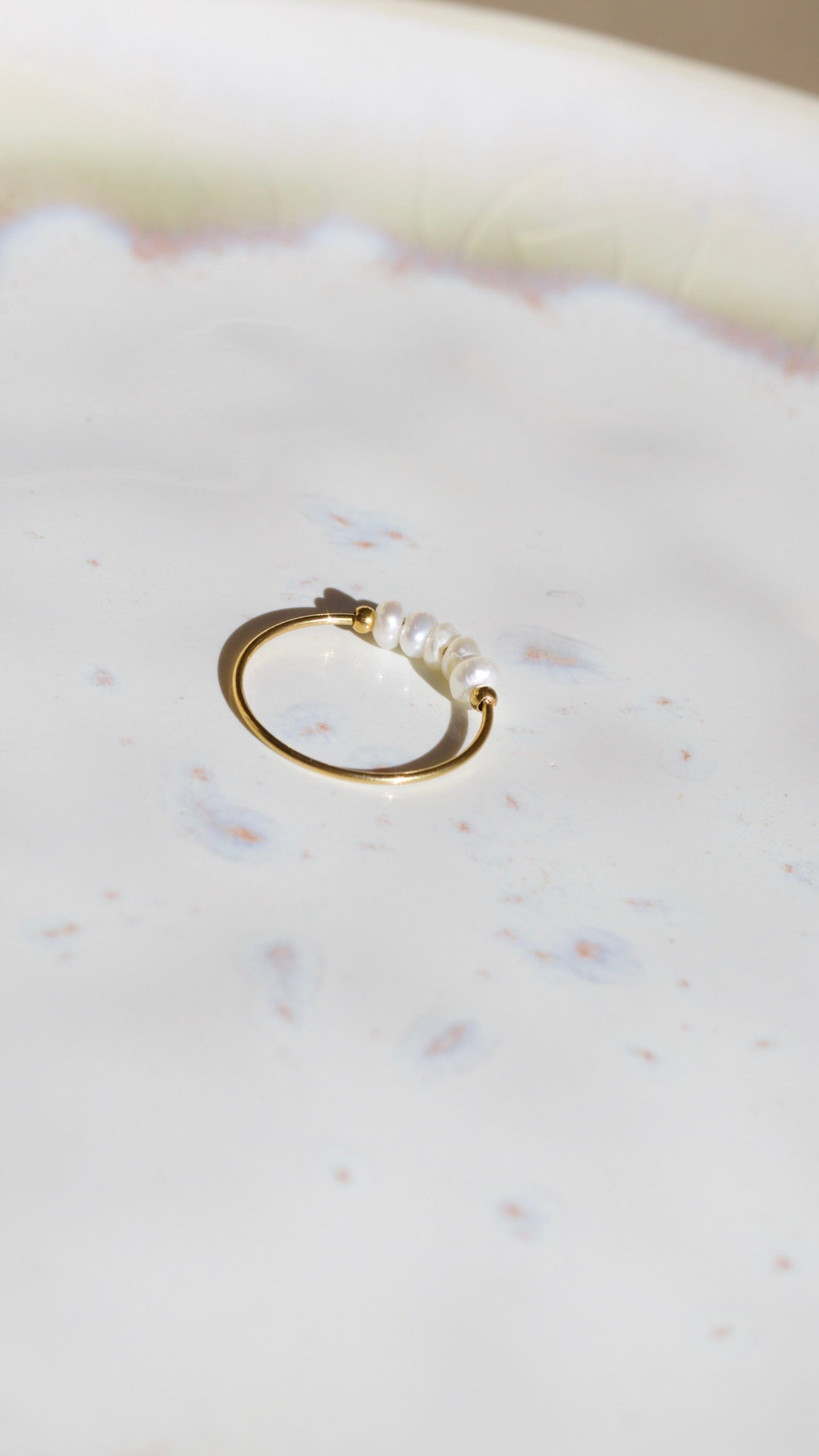 Gurk Pearl Ring Gold featuring a minimalist geometric design with genuine freshwater seed pearls and 18k gold plating.