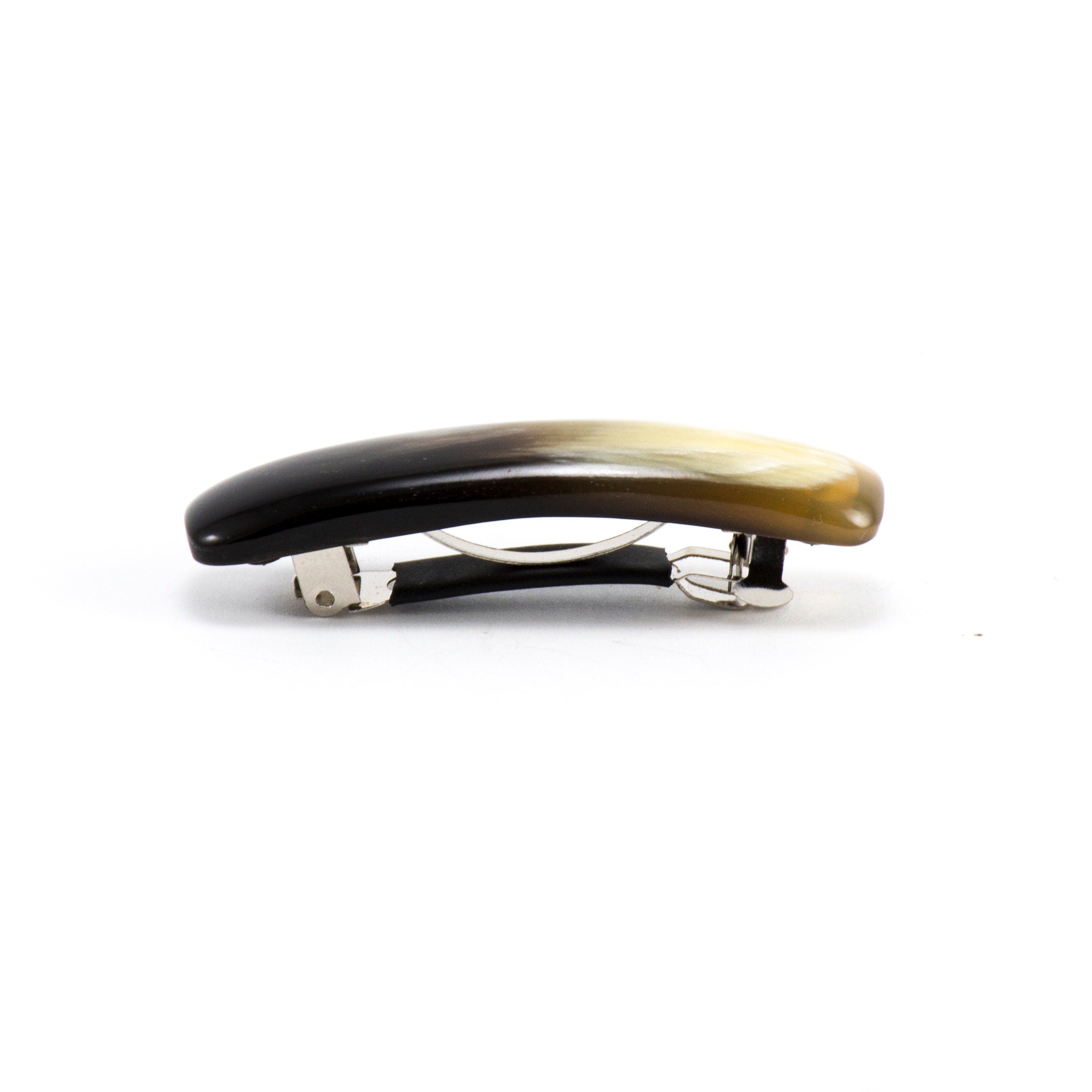 A stylish hair barrette designed like a French vending machine gun, featuring a rubber-covered upper part for hair safety.