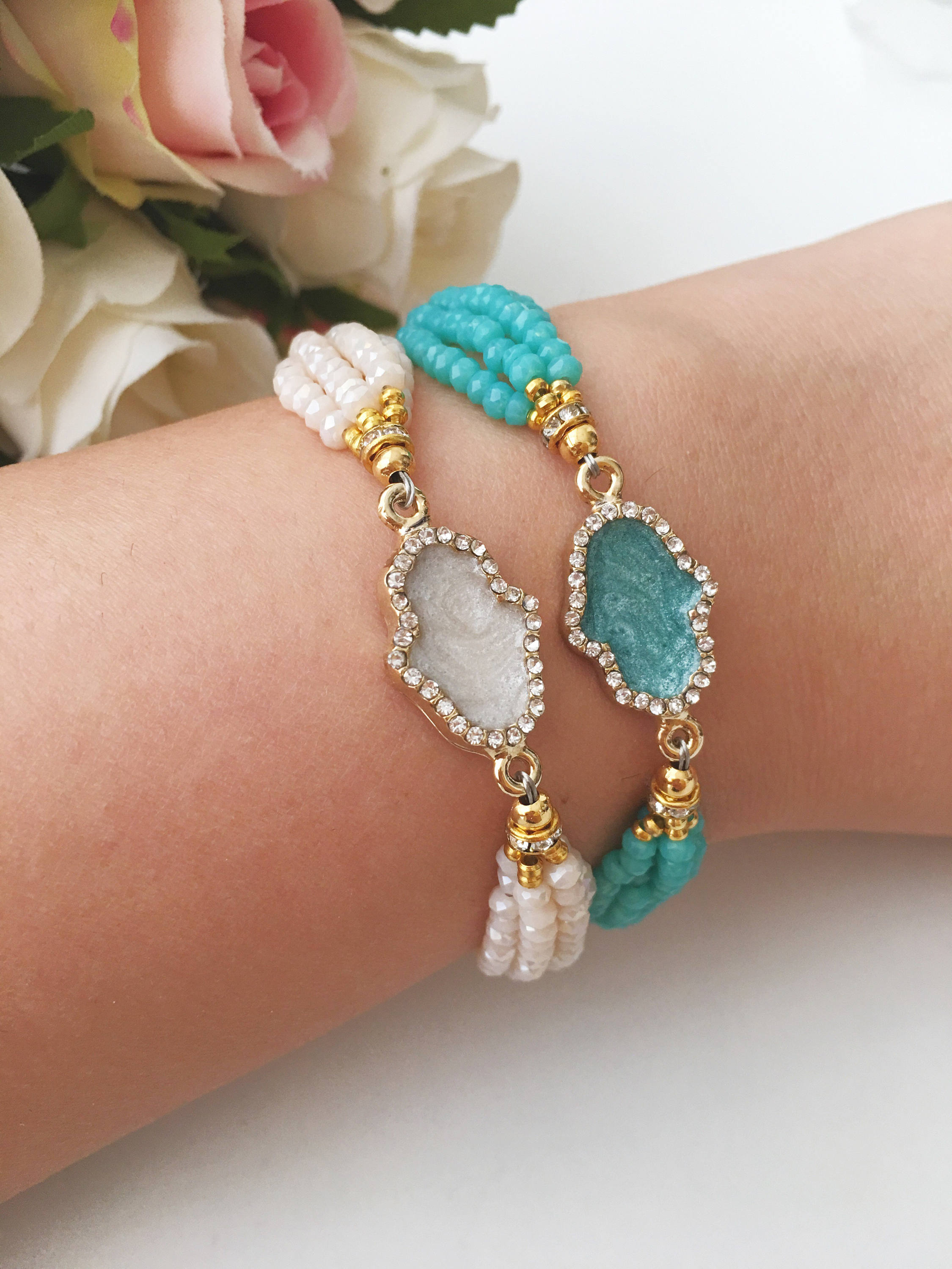 Handmade Hamsa Charm Bracelet featuring turquoise and white seed beads with a gold plated adjustable string.