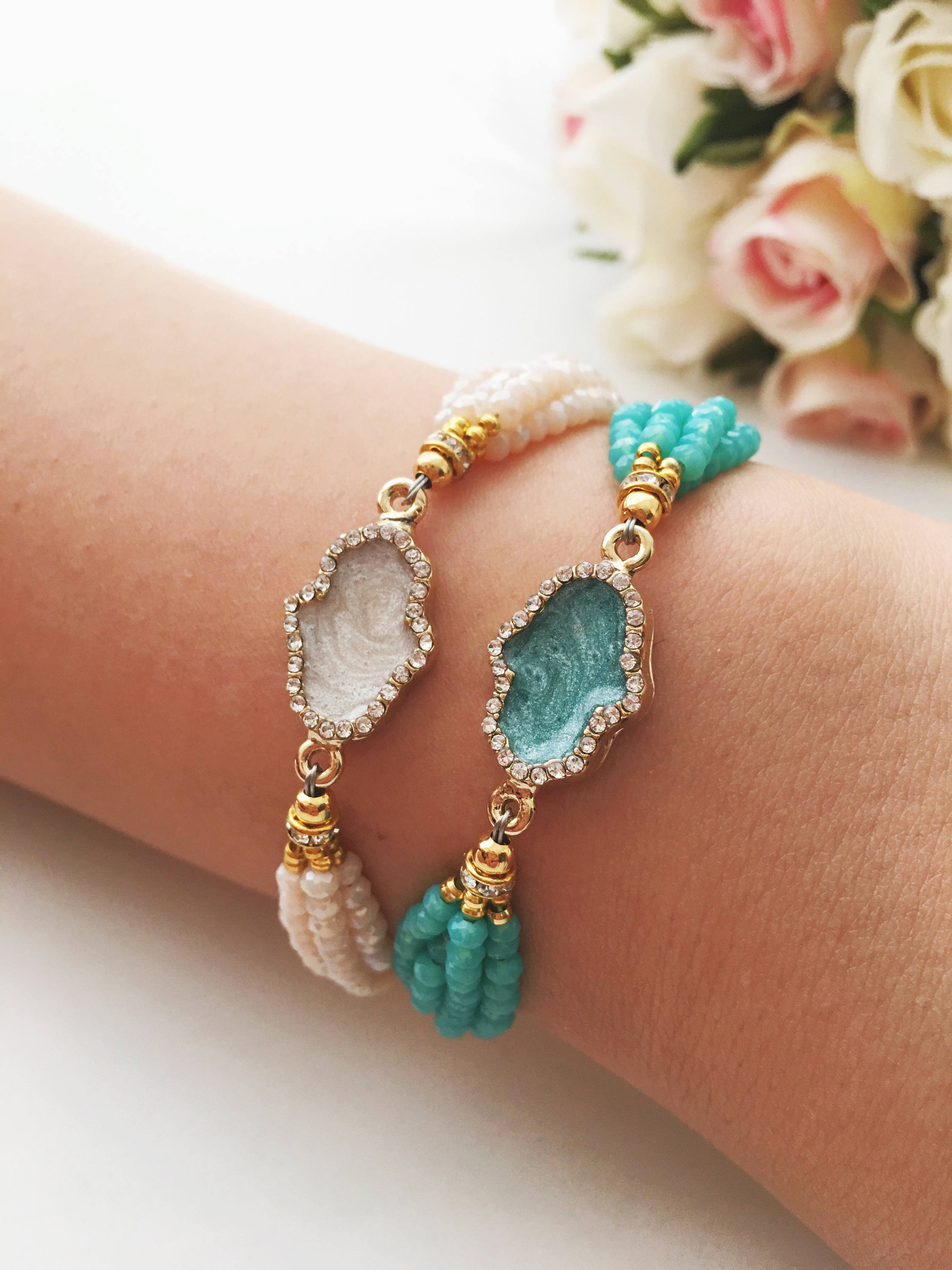 Handmade Hamsa Charm Bracelet featuring turquoise and white seed beads with a gold plated adjustable string.