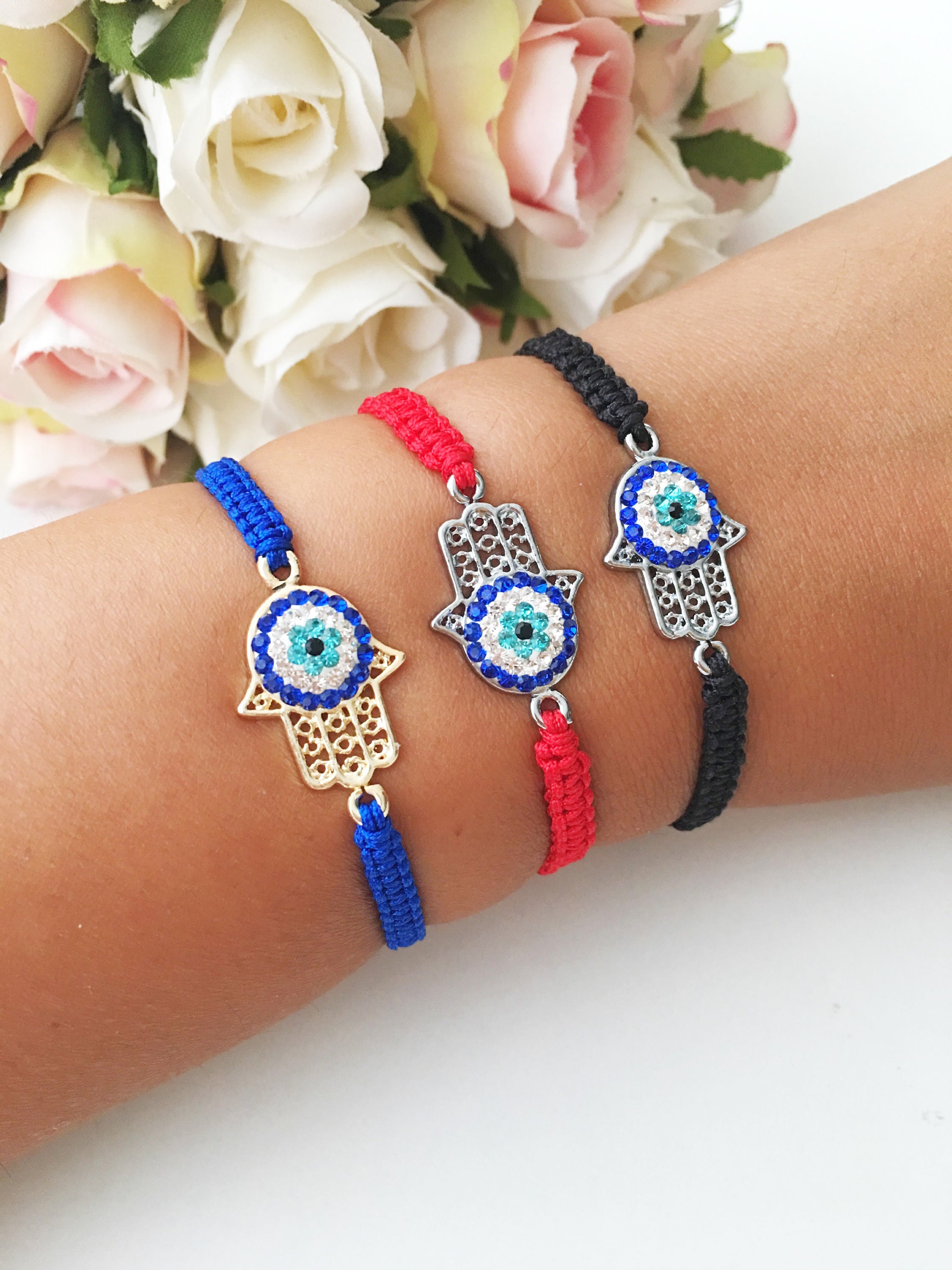 Handmade Hamsa Evil Eye Bracelet featuring silver or gold plating with adjustable macrame design and colorful string options.