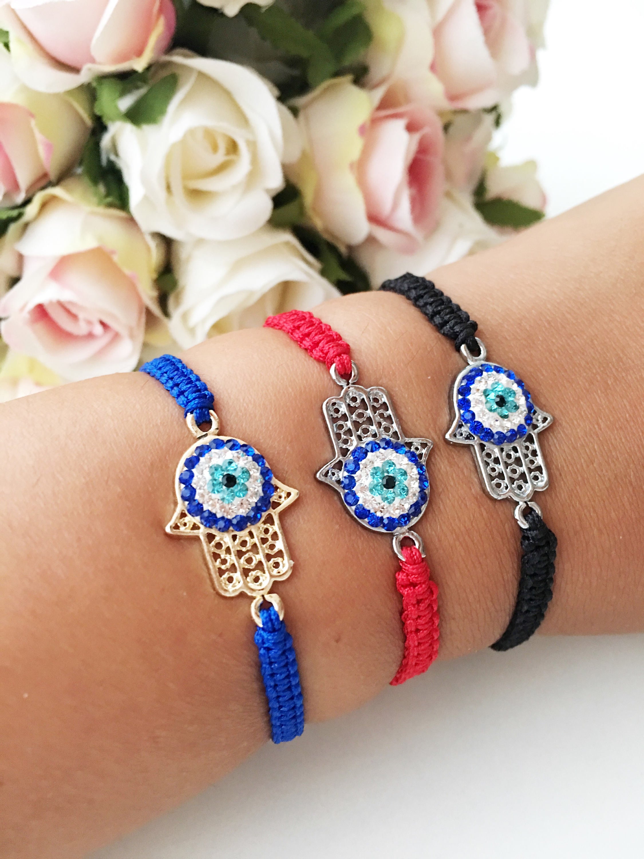 Handmade Hamsa Evil Eye Bracelet featuring silver or gold plating with adjustable macrame design and colorful string options.