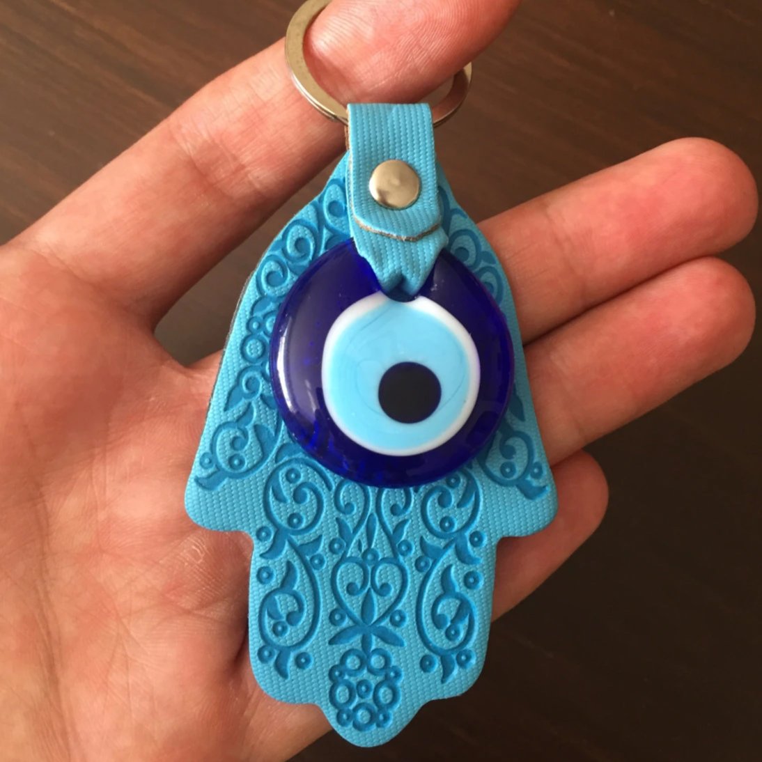 A beautifully designed Hamsa evil eye keychain featuring a Greek nazar bead, symbolizing protection and luck.