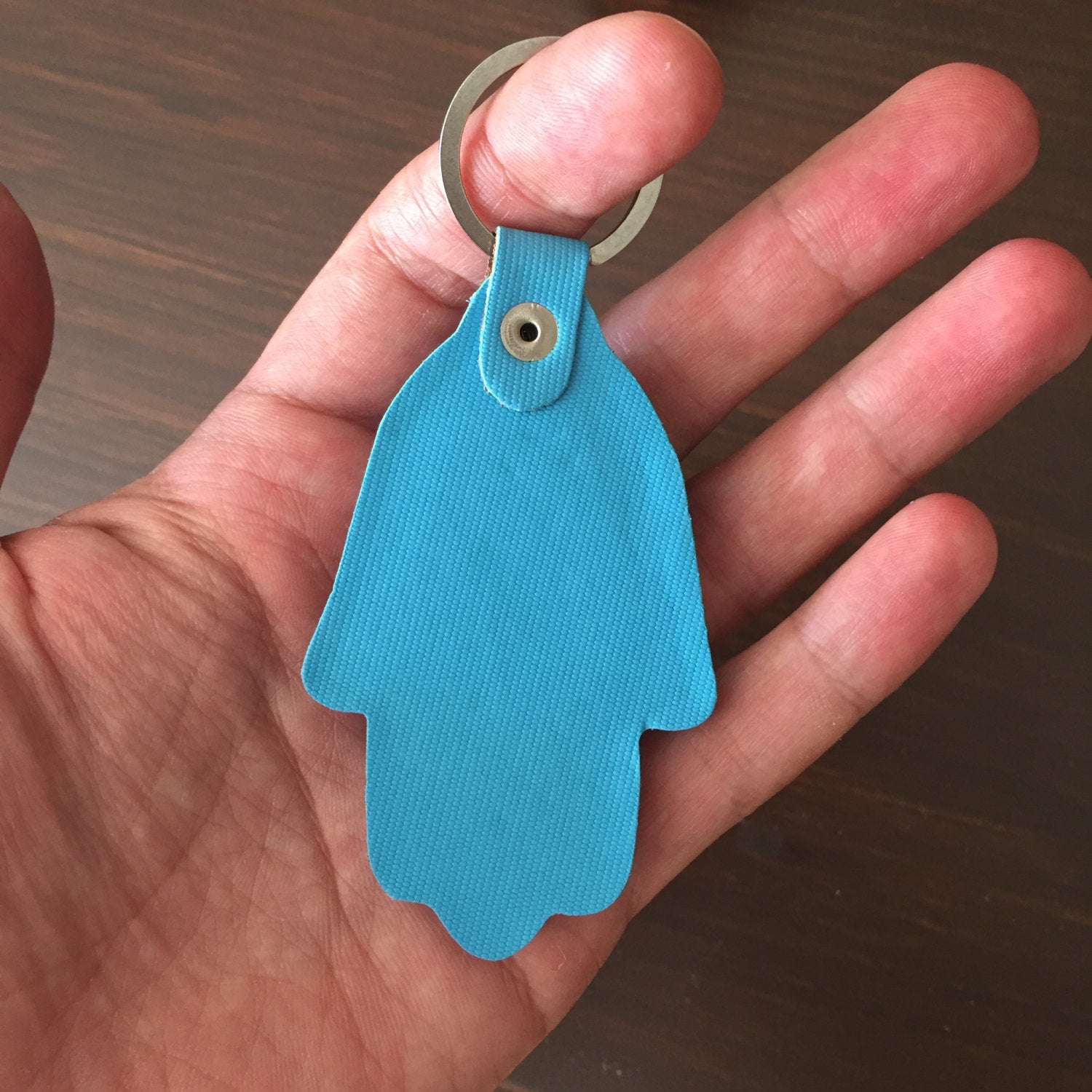 A beautifully designed Hamsa evil eye keychain featuring a Greek nazar bead, symbolizing protection and luck.