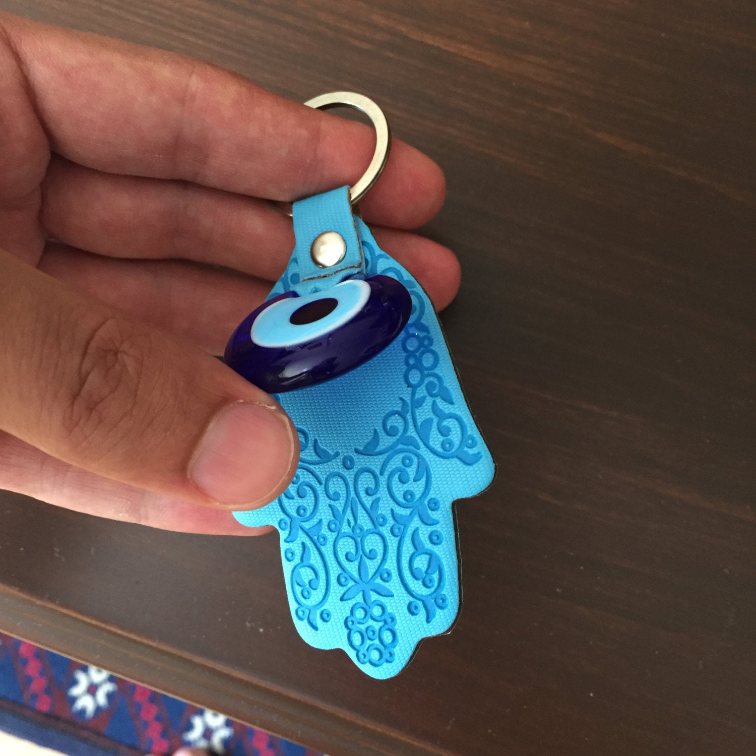 A beautifully designed Hamsa evil eye keychain featuring a Greek nazar bead, symbolizing protection and luck.