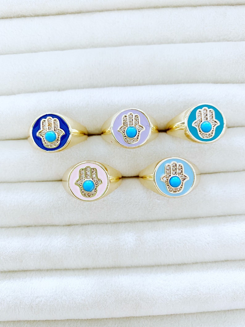 Adjustable Hamsa Evil Eye Ring with gold band and colorful hamsa charm, perfect for stacking.