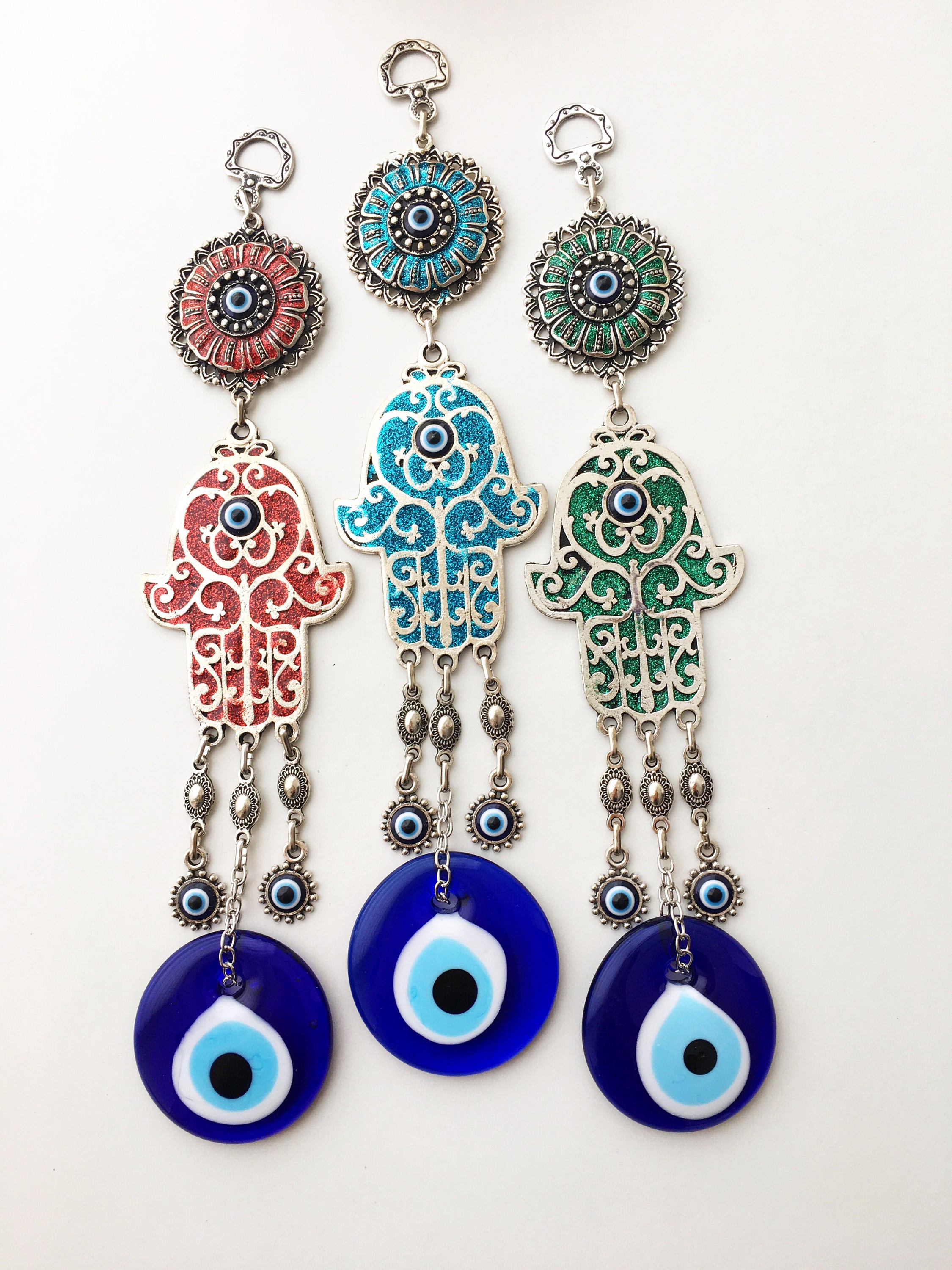 Hamsa Evil Eye Wall Art featuring a mosaic metal hand and a large evil eye bead in vibrant colors.