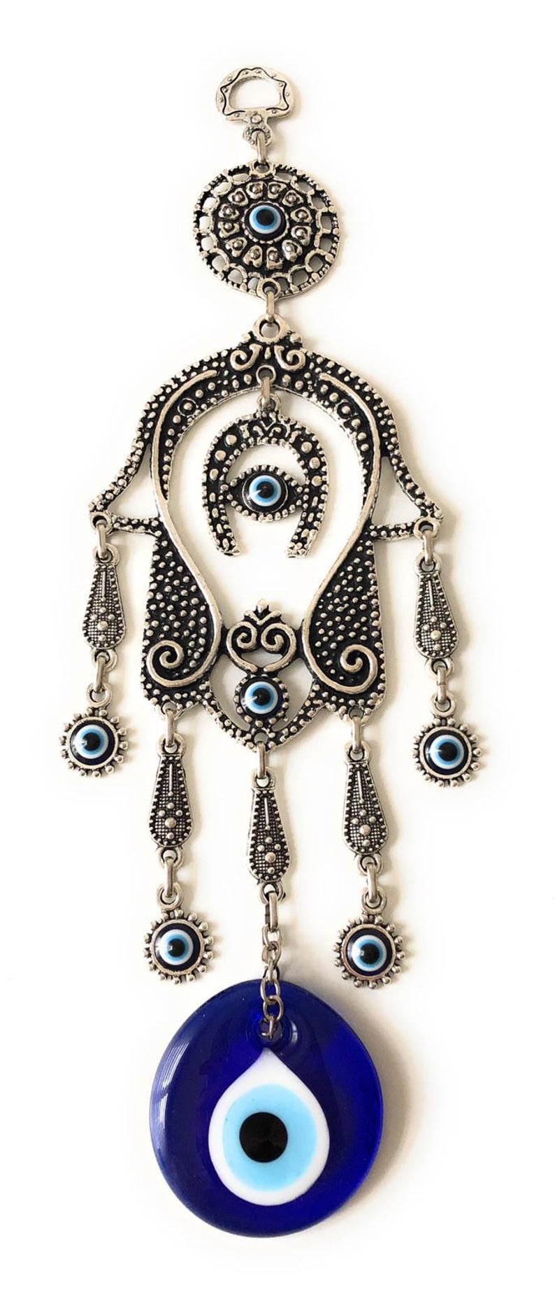 A beautifully crafted Hamsa evil eye wall decor featuring a mosaic metal hand and a large evil eye bead, symbolizing protection and good luck.