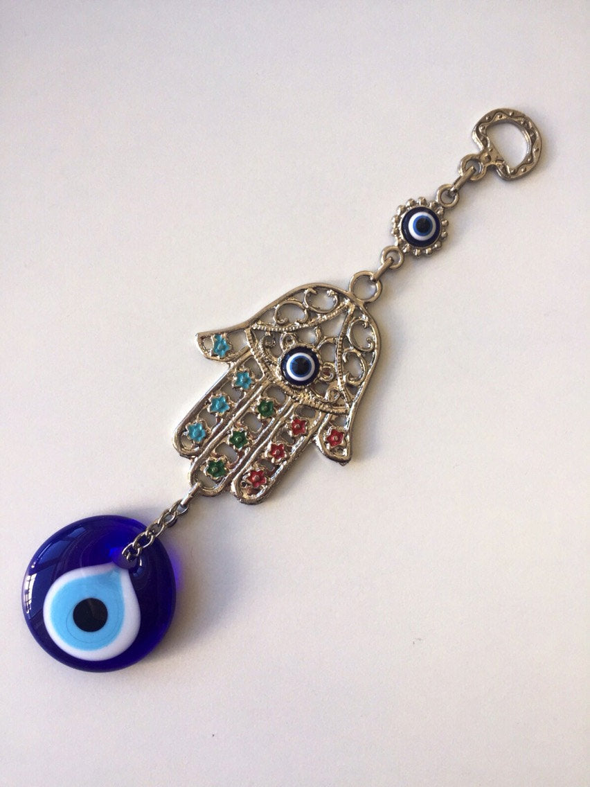 Handmade Hamsa Evil Eye Wall Decor featuring a metal Hamsa hand and a large evil eye bead, symbolizing protection and good luck.