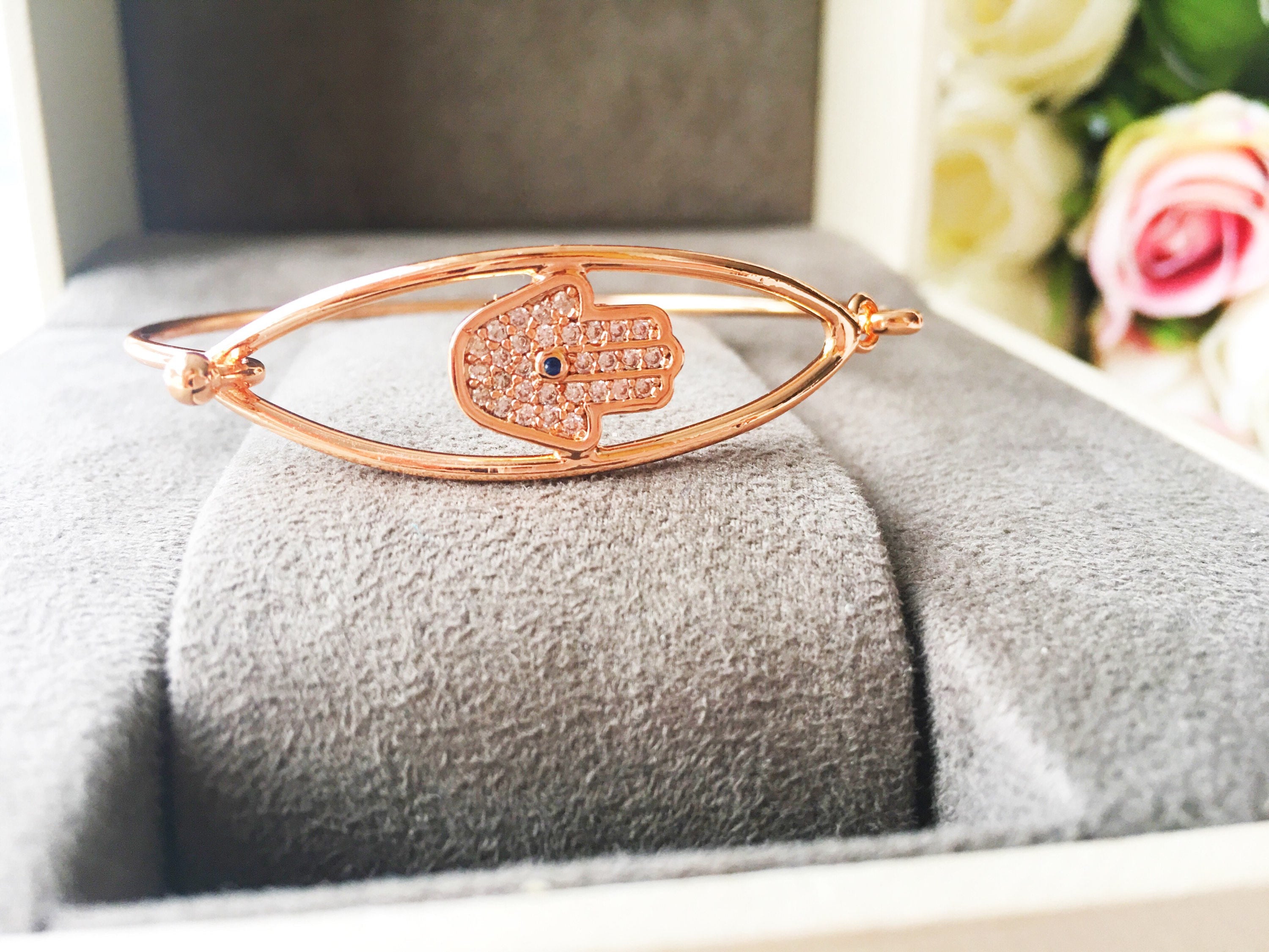 A beautiful rose gold Hamsa Hand Bracelet featuring a movable charm and adjustable design, showcasing its elegant craftsmanship.