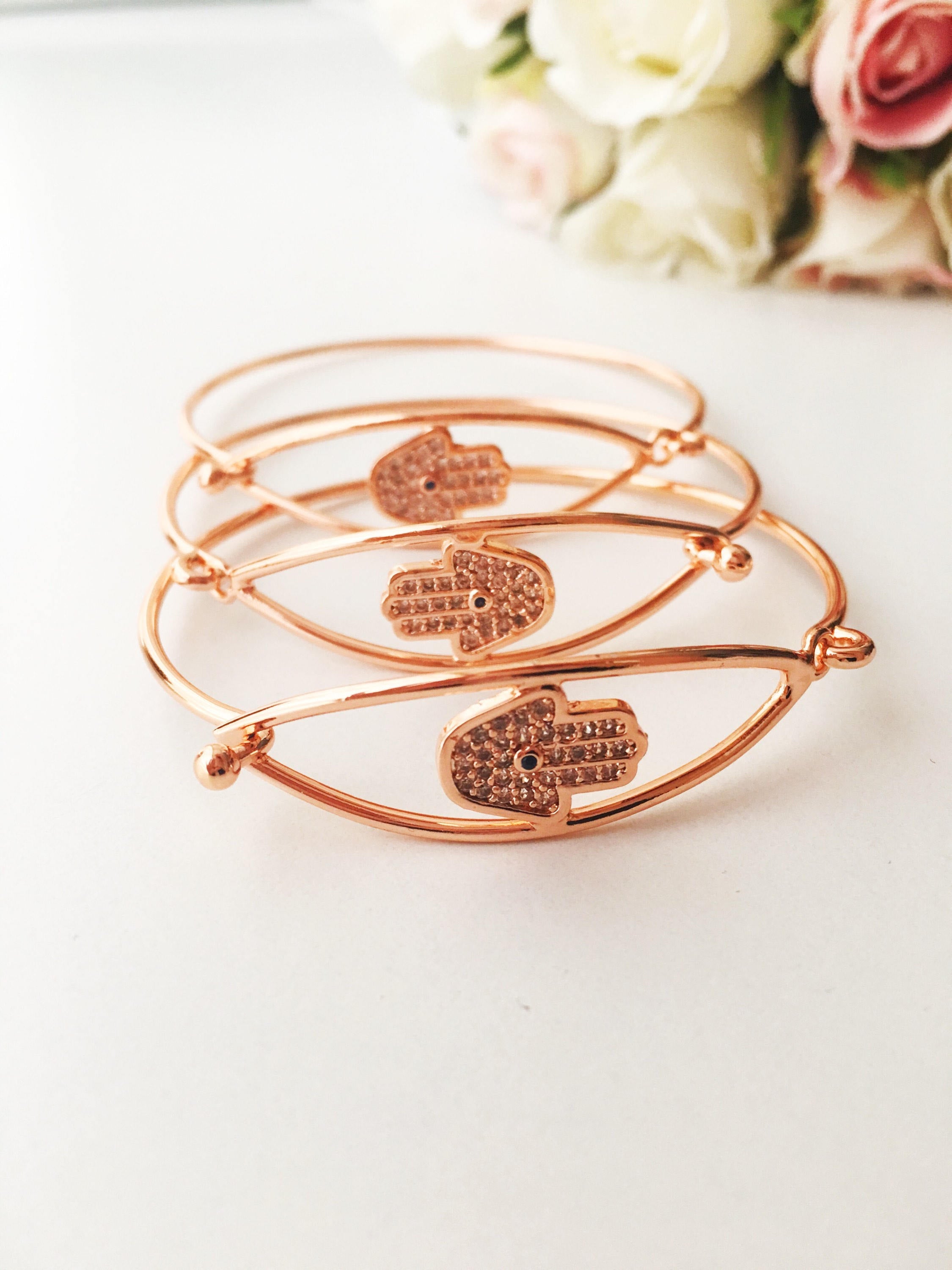 A beautiful rose gold Hamsa Hand Bracelet featuring a movable charm and adjustable design, showcasing its elegant craftsmanship.