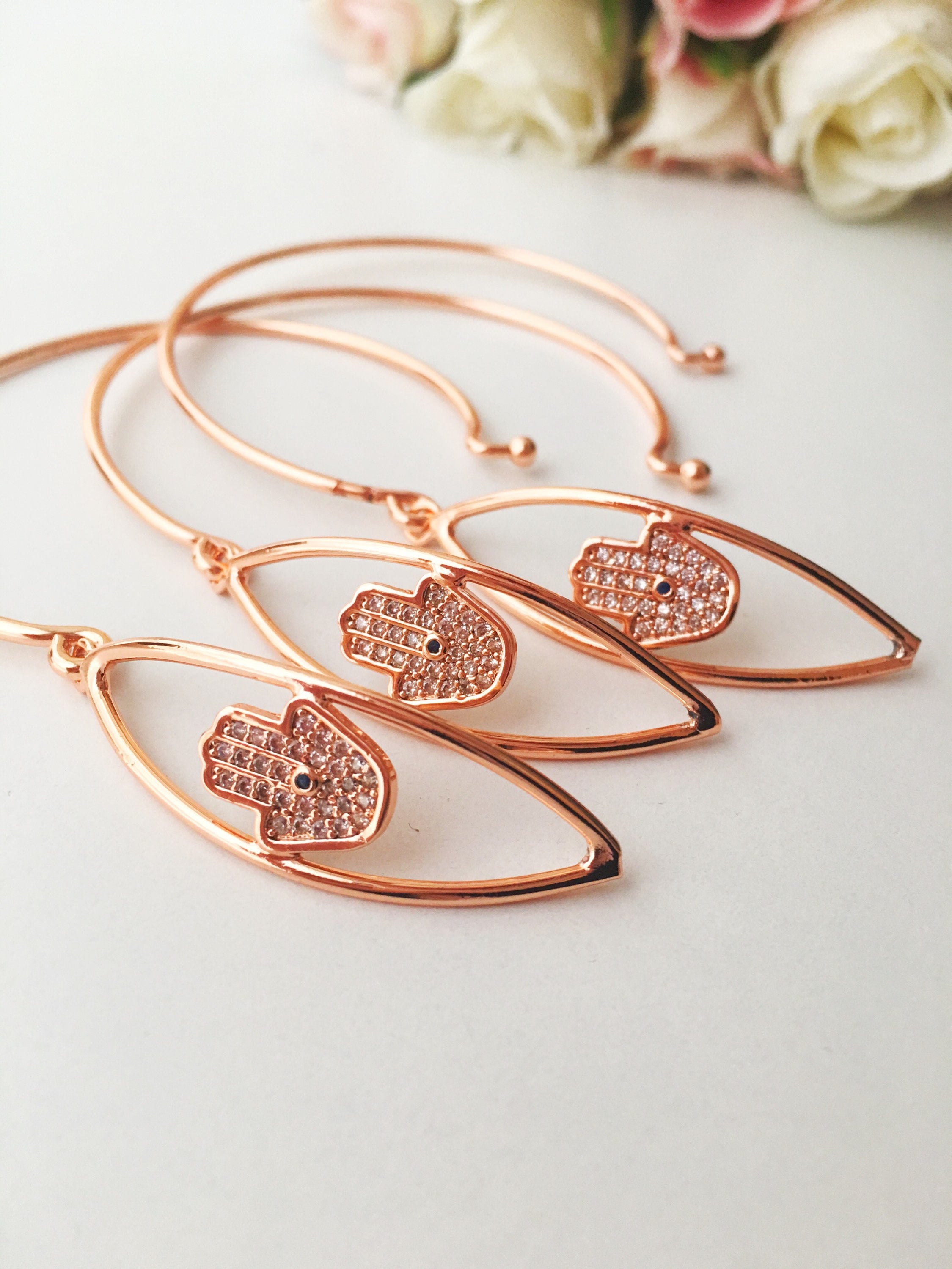 A beautiful rose gold Hamsa Hand Bracelet featuring a movable charm and adjustable design, showcasing its elegant craftsmanship.