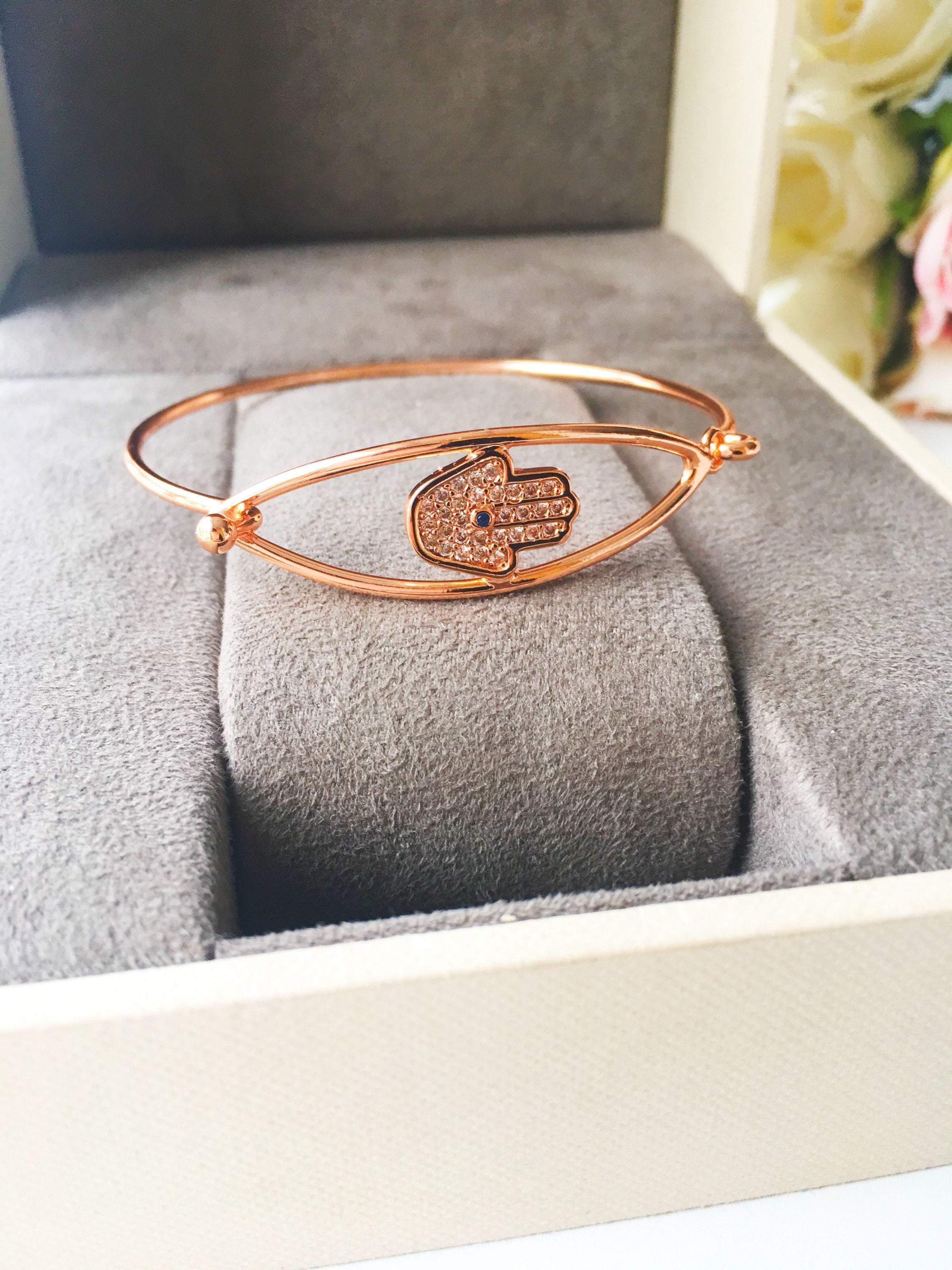 A beautiful rose gold Hamsa Hand Bracelet featuring a movable charm and adjustable design, showcasing its elegant craftsmanship.