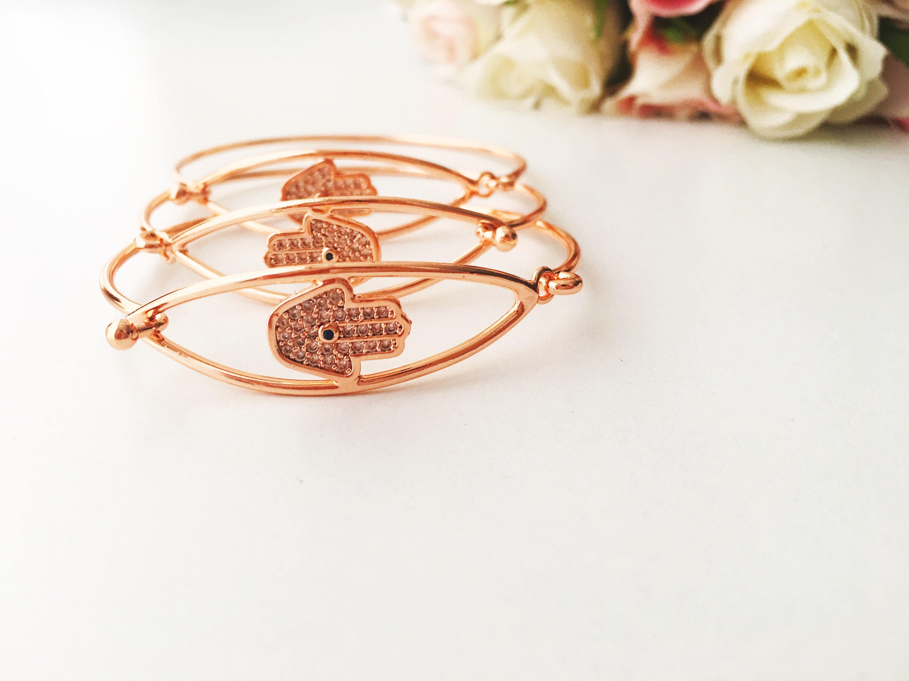 A beautiful rose gold Hamsa Hand Bracelet featuring a movable charm and adjustable design, showcasing its elegant craftsmanship.