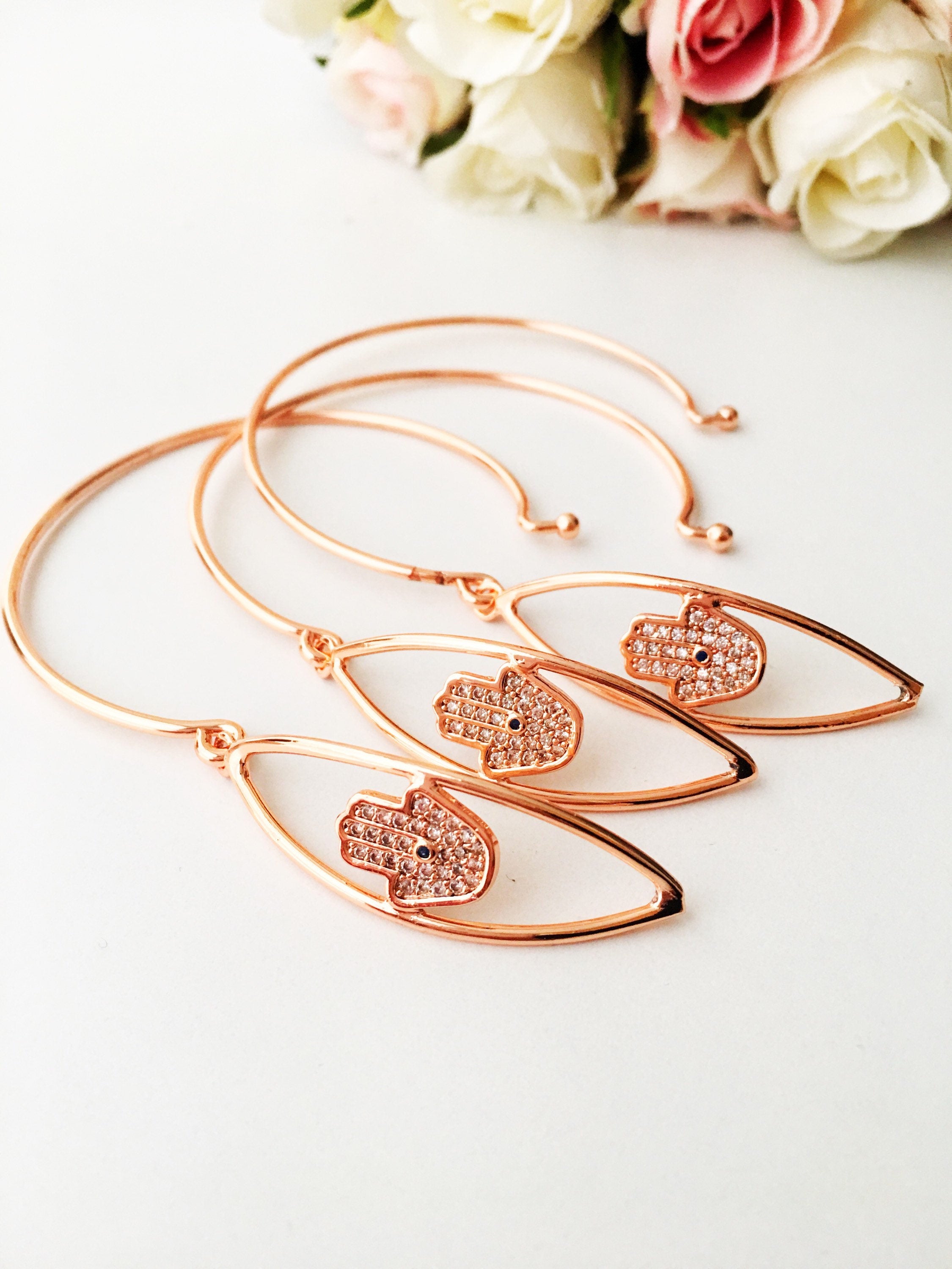 A beautiful rose gold Hamsa Hand Bracelet featuring a movable charm and adjustable design, showcasing its elegant craftsmanship.