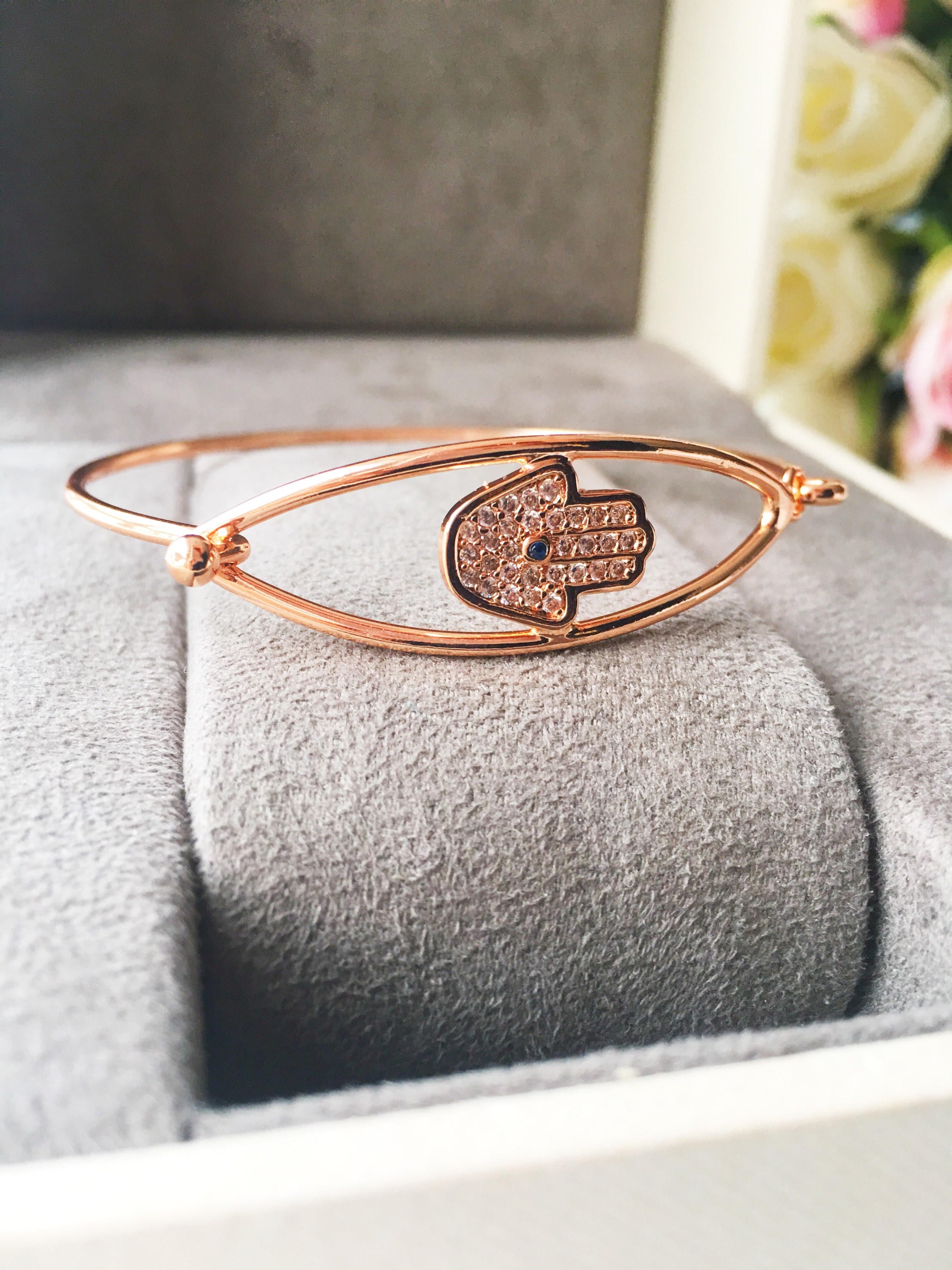 A beautiful rose gold Hamsa Hand Bracelet featuring a movable charm and adjustable design, showcasing its elegant craftsmanship.