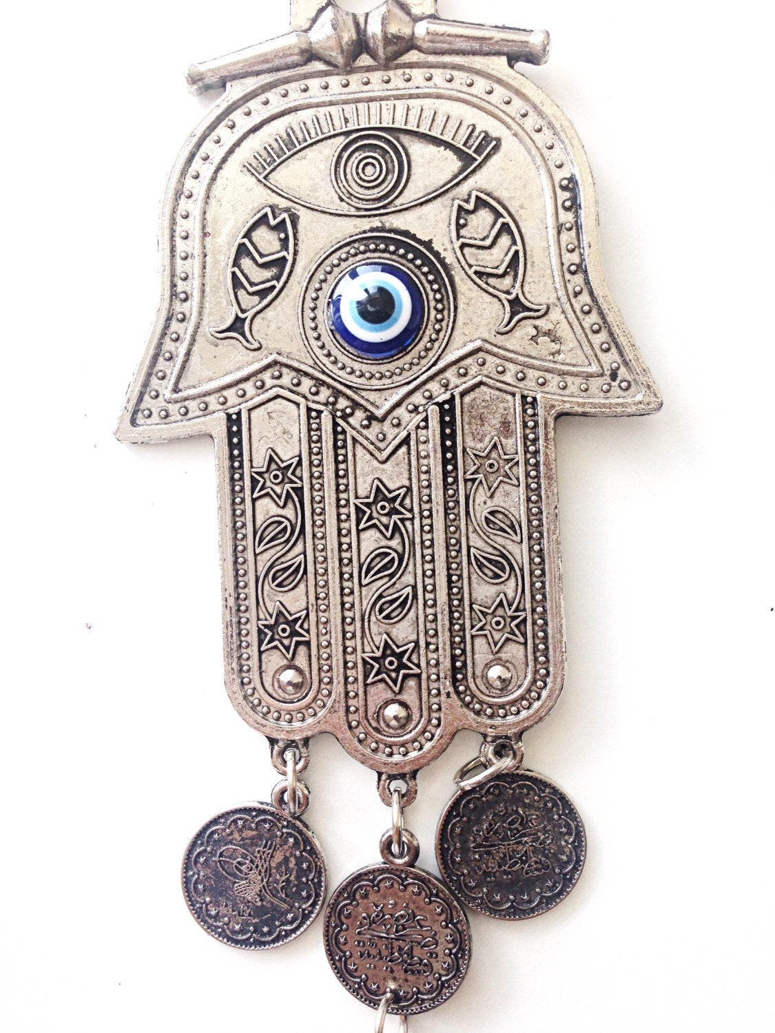 Hamsa wall art featuring a metal hand and large evil eye bead, symbolizing protection and good luck, beautifully crafted for home decor.