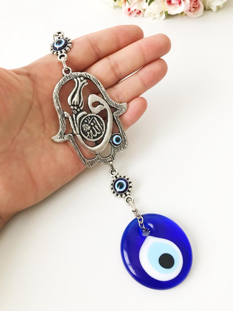 Hamsa wall decor featuring a metal hand and large evil eye bead, beautifully crafted for Islamic wall art.