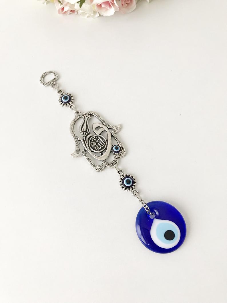 Hamsa wall decor featuring a metal hand and large evil eye bead, beautifully crafted for Islamic wall art.