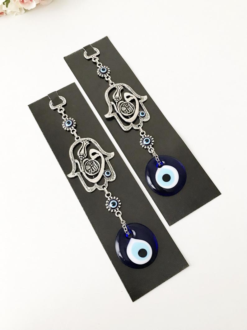 Hamsa wall decor featuring a metal hand and large evil eye bead, beautifully crafted for Islamic wall art.