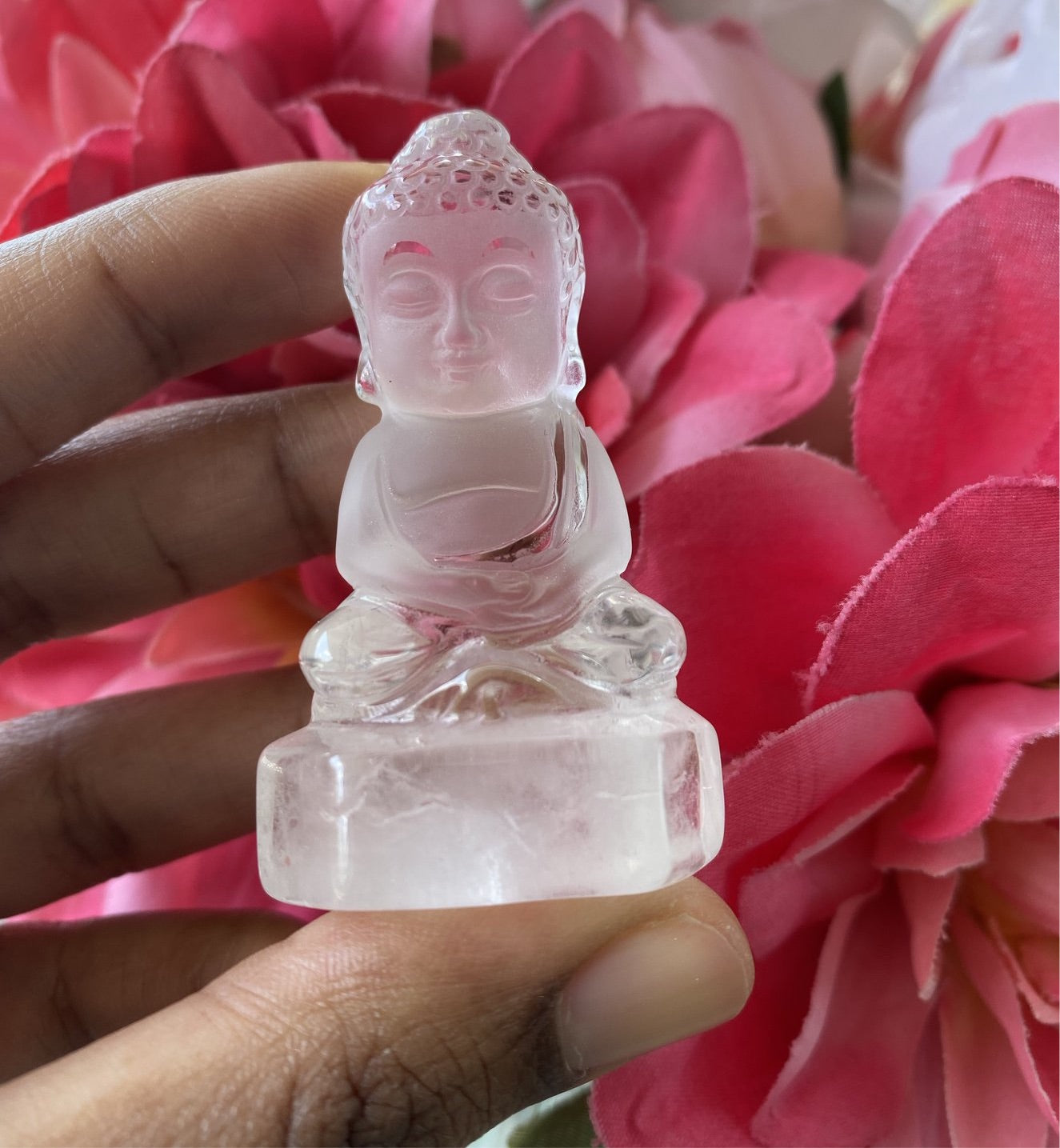 A charming hand carved Baby Buddha statue made of Clear Quartz, measuring 2.5 inches, radiating positive energy.