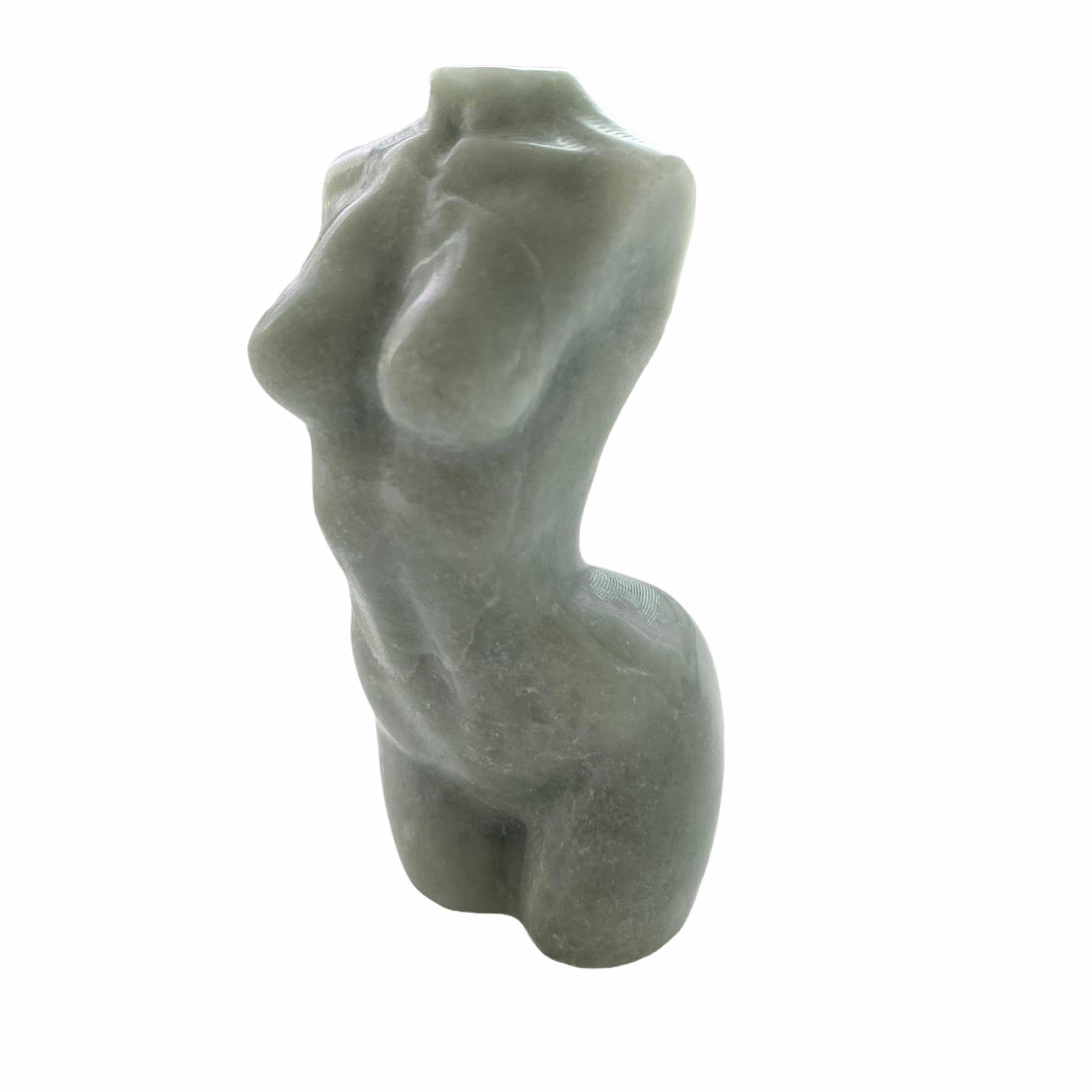 A beautifully hand carved female form statue made from natural stone, showcasing intricate details and celebrating femininity.