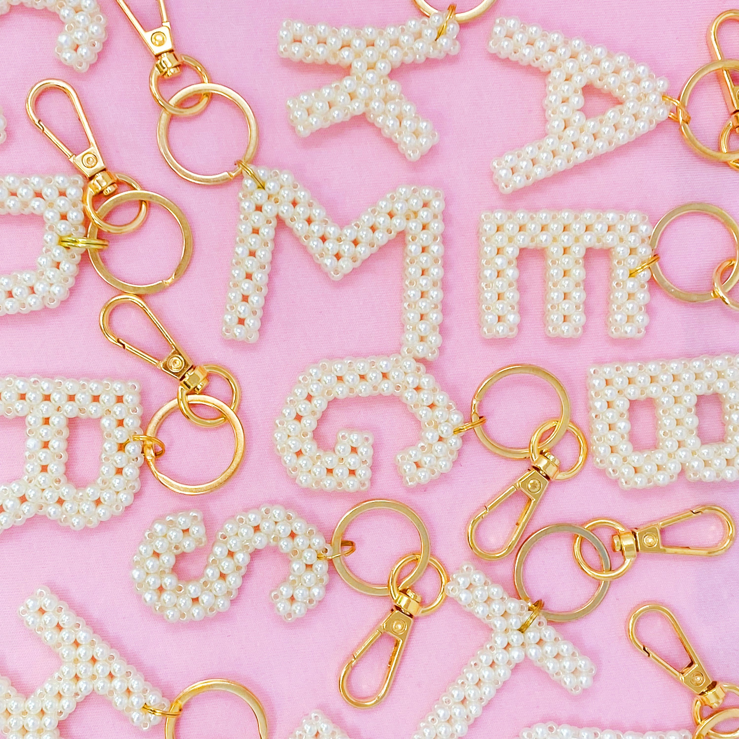 Hand knitted retro pearl initial key chain featuring pearl beads and gold tone hardware, personalized with an initial charm.