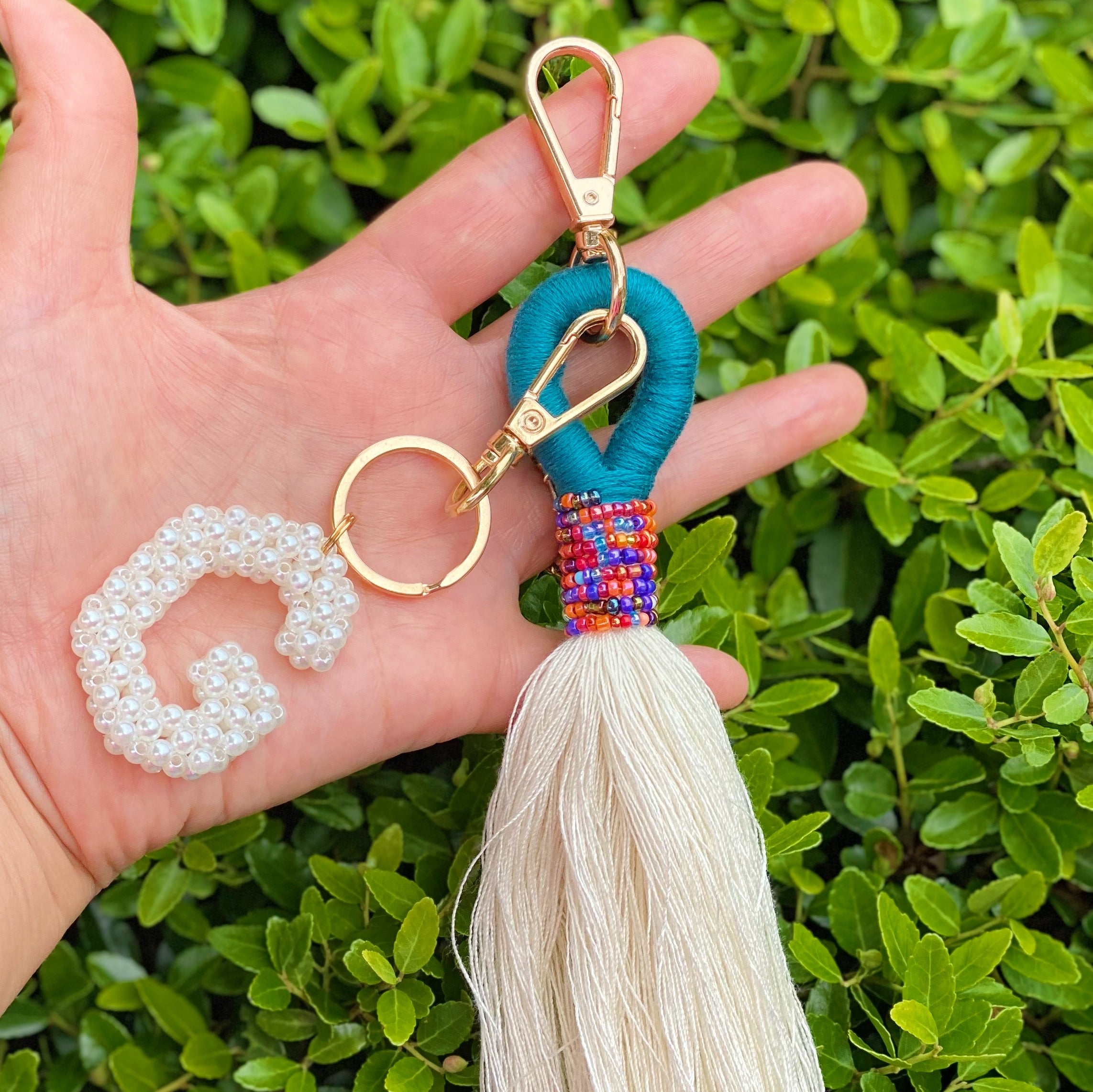 Hand knitted retro pearl initial key chain featuring pearl beads and gold tone hardware, personalized with an initial charm.